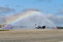 U.S. Air Force Col. Shawn E. Anger, the 354th Fighter Wing commander, taxis down the flight line during his fini flight at Eielson Air Force Base, Alaska, Aug. 13, 2020. Per tradition, the pilot will taxi his aircraft under streams of water during the last portion of a fini flight. (U.S. Air Force photo by Senior Airman Beaux Hebert)