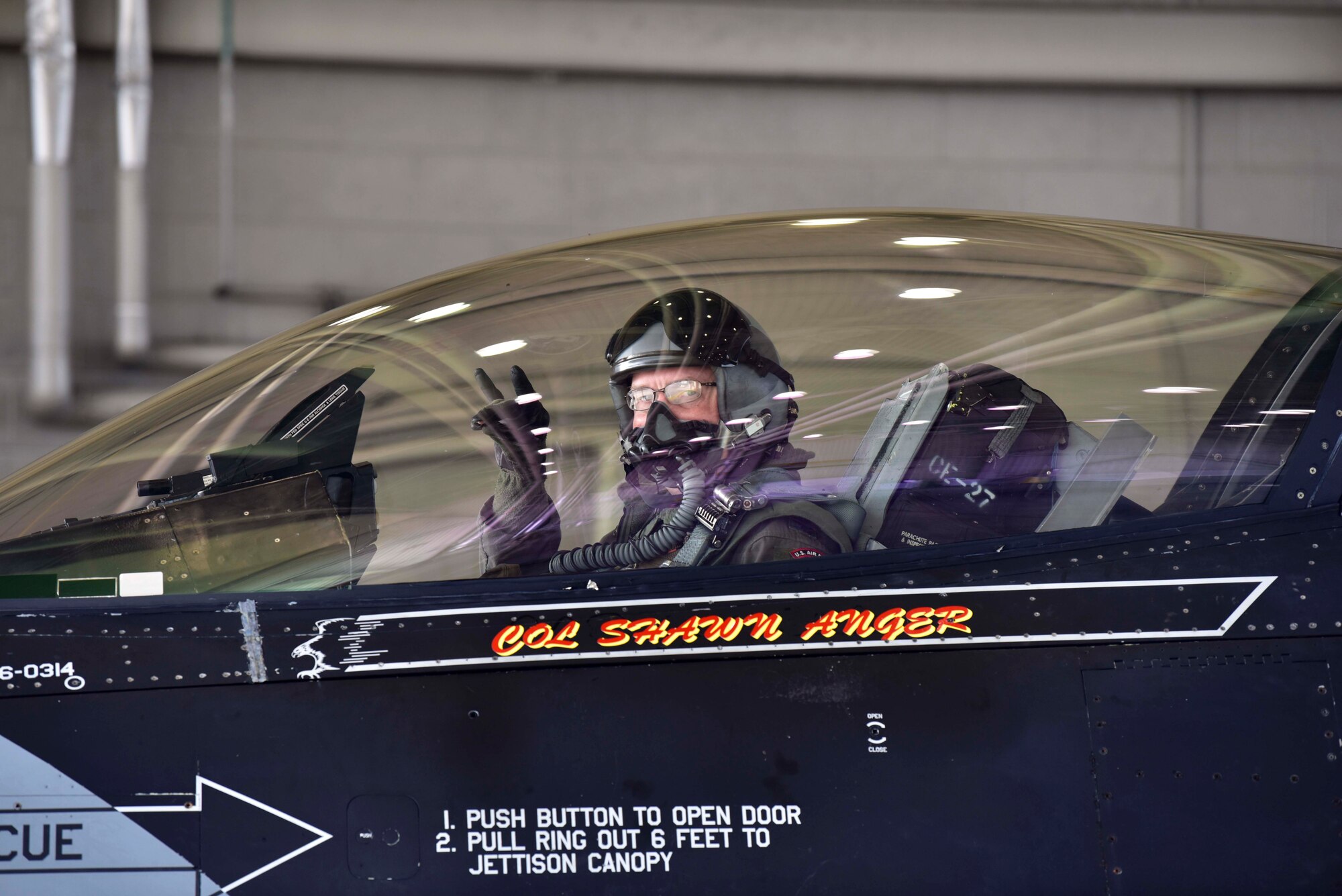 U.S. Air Force Col. Shawn E. Anger, the 354th Fighter Wing commander, renders the 18th Aggressor Squadron ‘have at you’ gesture during his fini flight at Eielson Air Force Base, Alaska, Aug. 13, 2020. Anger is a command pilot with more than 2,900 hours flight hours throughout his career. (U.S. Air Force photo by Senior Airman Beaux Hebert)