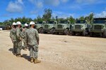 TINIAN, Commonwealth of the Northern Mariana Islands (Aug. 10, 2020) Rear Adm. John Menoni, commander of Joint Region Marianas center front, and Capt. Eric Correll, commodore for Commander Task Force 75, center rear, tour the Alfa Company yard with Lt. j.g. Aaron Ignacio, right, and Senior Chief Equipment Operator Matthew Kreamalmyer, left, U.S. Naval Mobile Construction Battalion (NMCB) 3’s officer-in-charge and assistant officer-in-charge, respectively. NMCB-3 is deployed across the Indo-Pacific region conducting high-quality construction to support U.S. and partner nations to strengthen partnerships, deter aggression, and enable expeditionary logistics and naval power projection. The battalion stands ready to complete assigned tasking, support Humanitarian Aid/Disaster Relief and Major Combat Operations throughout the area of operations. (U.S. Navy photo by Construction Electrician 3rd ClassConstructionman Marcus Henley/Released)