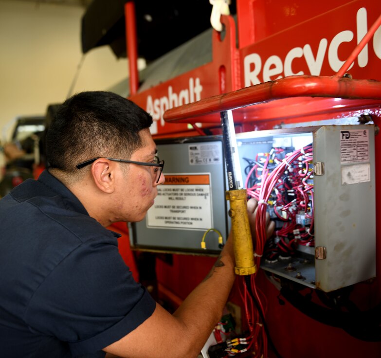Airman fixes a vehicle.