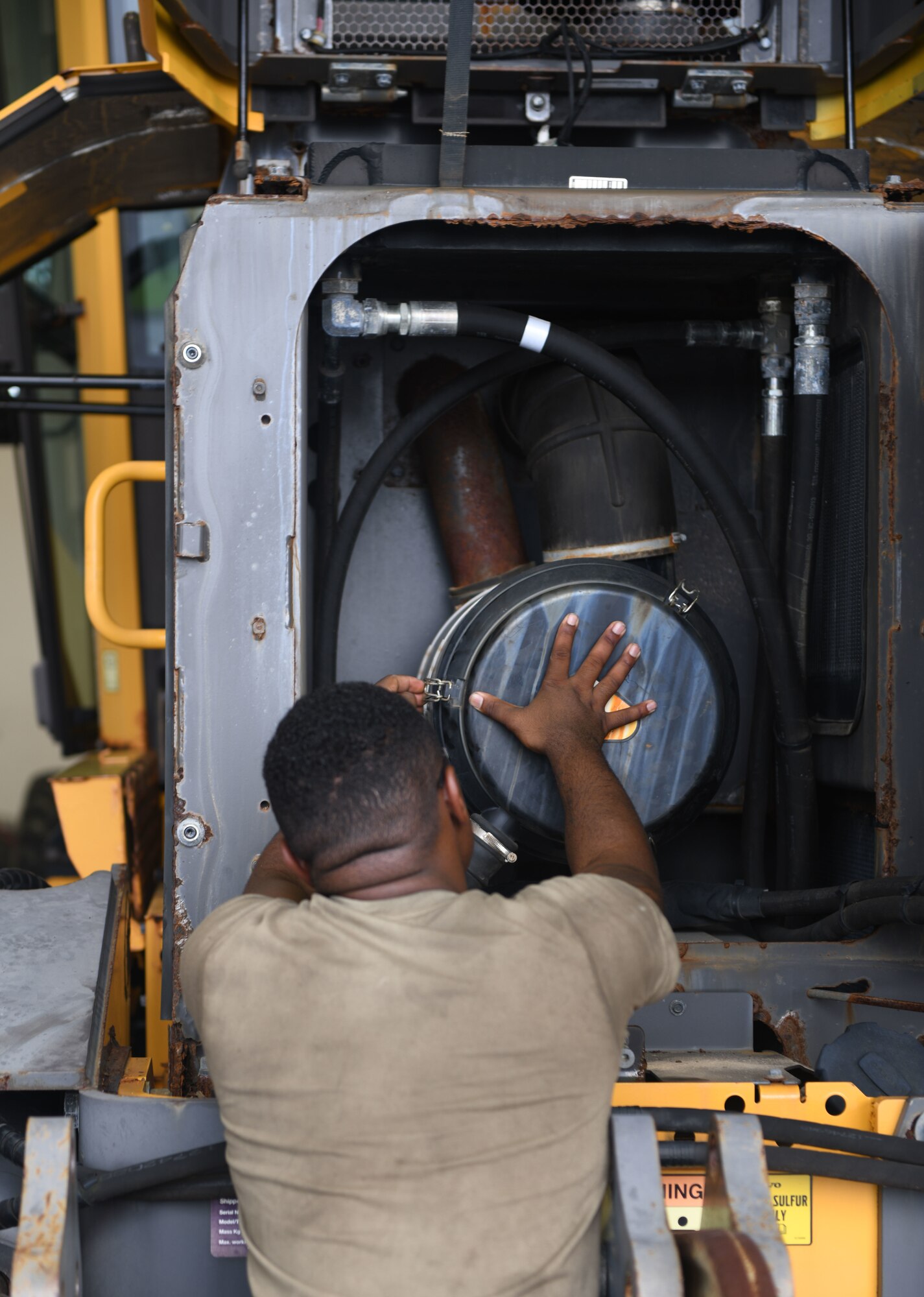 Airman replaces a filter.