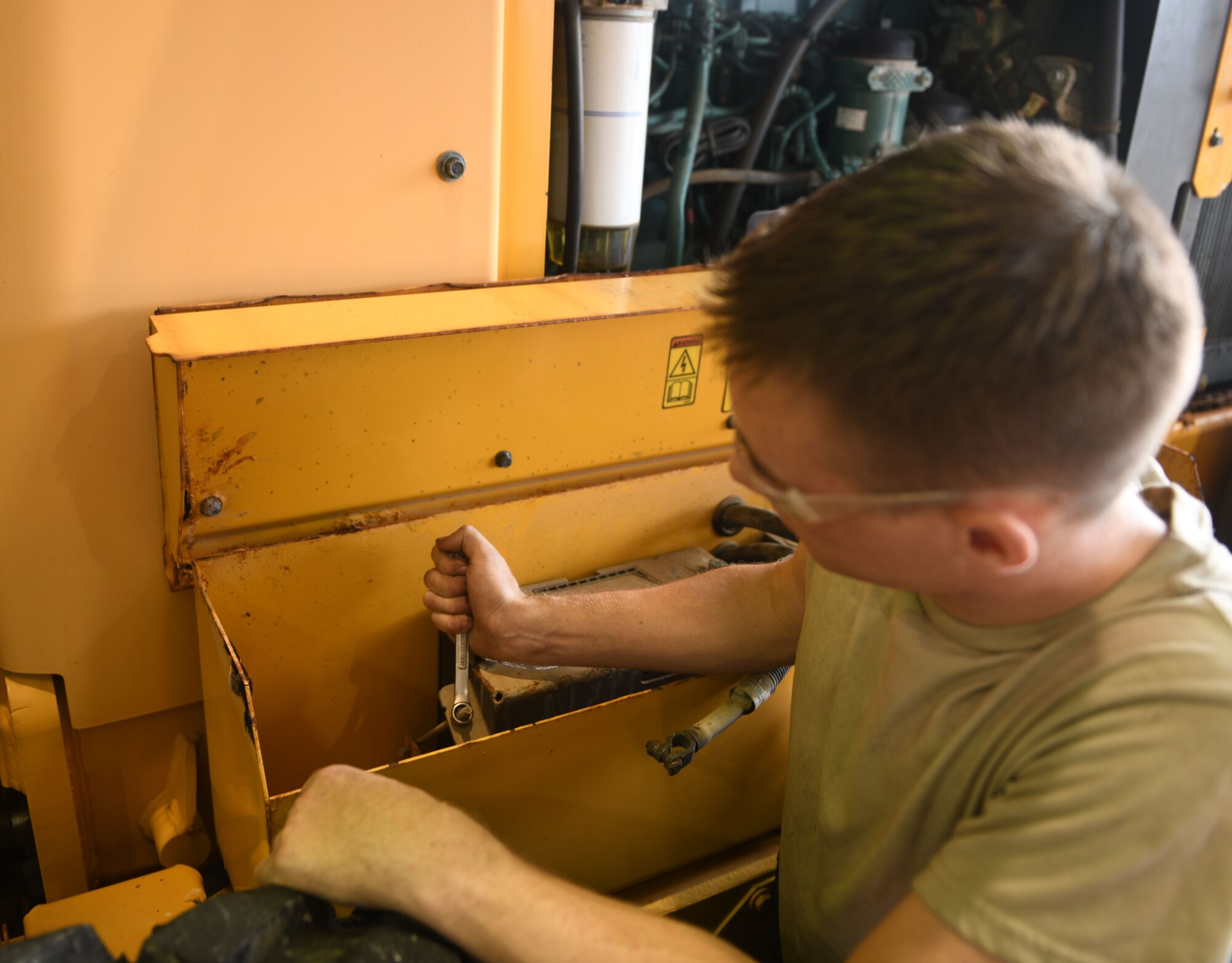 Vehicle maintainer fixing a vehicle.