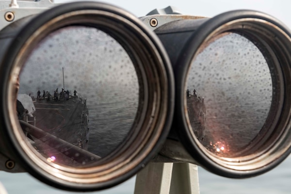 A reflection is seen in a set of binoculars.