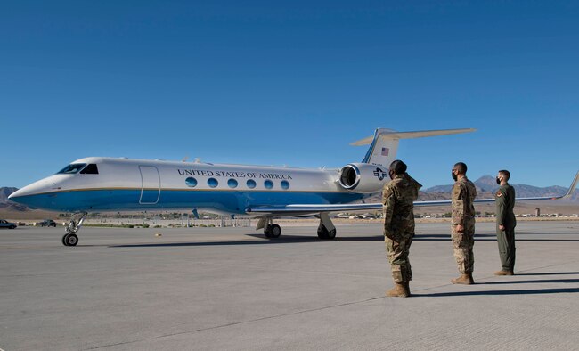 Leadership from Creech Air Force Base salute the aircraft carrying Secretary of the AF Barrett on the flight line.