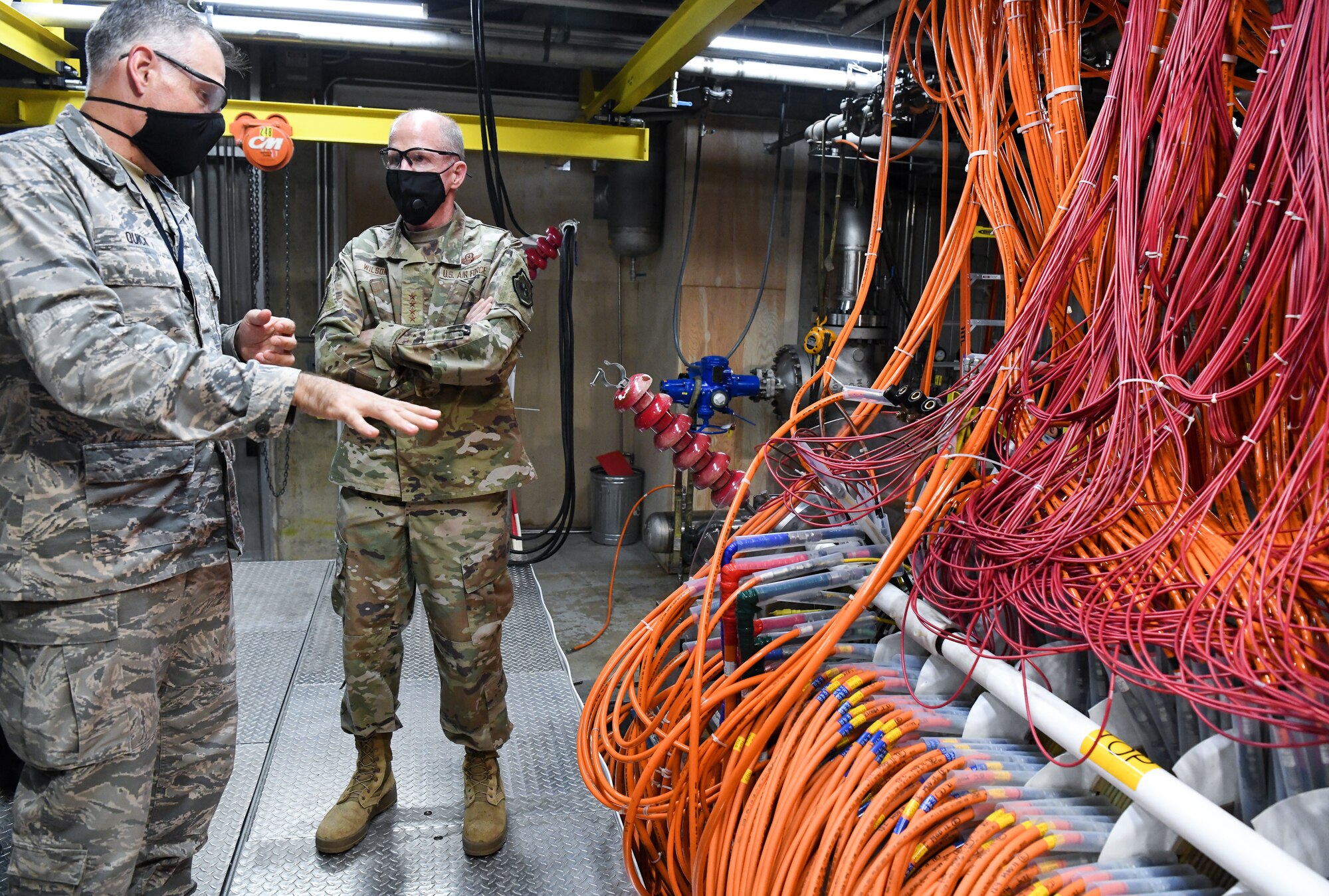 Lt. Col. Adam Quick, left, director of the Arnold Engineering Development Complex (AEDC) Space and Missile Branch, briefs Vice Chief of Staff of the Air Force Gen. Stephen Wilson as they walk through part of the arc heater facility Aug. 11, 2020, at Arnold Air Force Base, Tenn. Arc heaters allow for the testing of thermal protection systems in simulated environments representative of hypersonic flight. (U.S. Air Force photo by Jill Pickett)