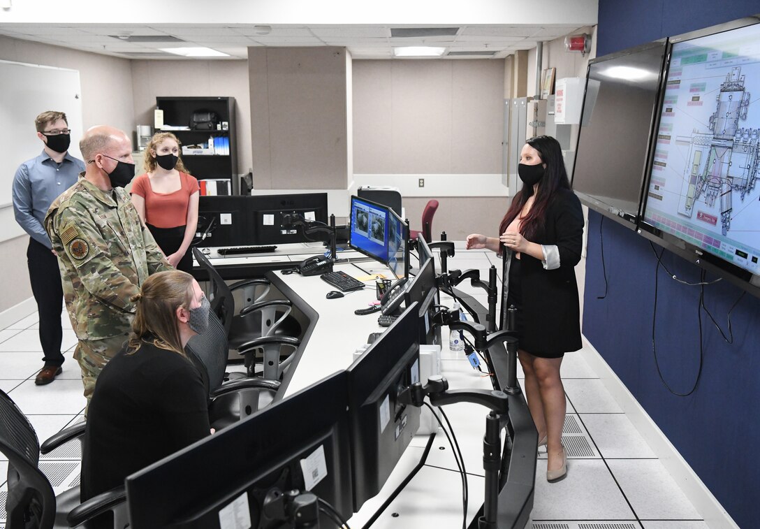 Kellye Burns, right, an Arnold Engineering Development Complex (AEDC) space test engineer, briefs Vice Chief of Staff of the Air Force Gen. Stephen Wilson on the Space Threat Assessment Testbed (STAT) during his visit to Arnold Air Force Base, Tenn., Aug. 11, 2020. Wilson visited STAT, arc heaters, the 16-foot Transonic Wind Tunnel and the C-2 engine test cell while at Arnold AFB. (U.S. Air Force photo by Jill Pickett)