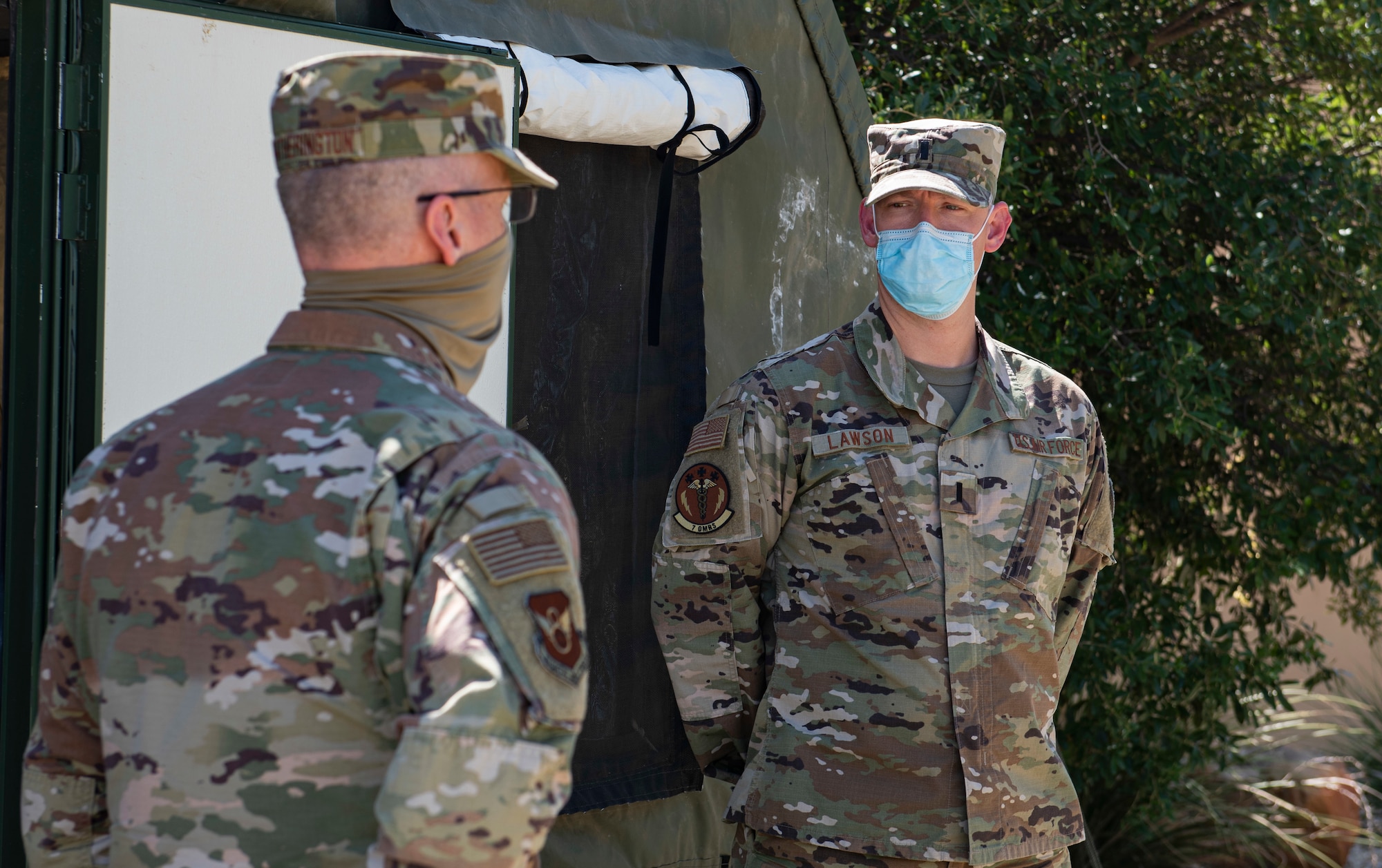 Maj. Gen. Mark Weatherington, 8th Air Force and Joint-Global Strike Operations Center commander, left, speaks with 1st Lt. William Lawson, 7th Operational Medical Readiness Squadron physician assistant, at Dyess Air Force Base, Texas, Aug. 11, 2020.