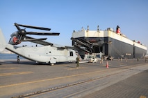 U.S. Marines with Marine Medium Tiltrotor Squadron 166 (Reinforced), assigned to Special Purpose Marine Air-Ground Task Force - Crisis Response - Central Command 20.2, move an MV-22 Osprey off the U.S.-flagged vehicle carrier, the Green Ridge, in Kuwait.