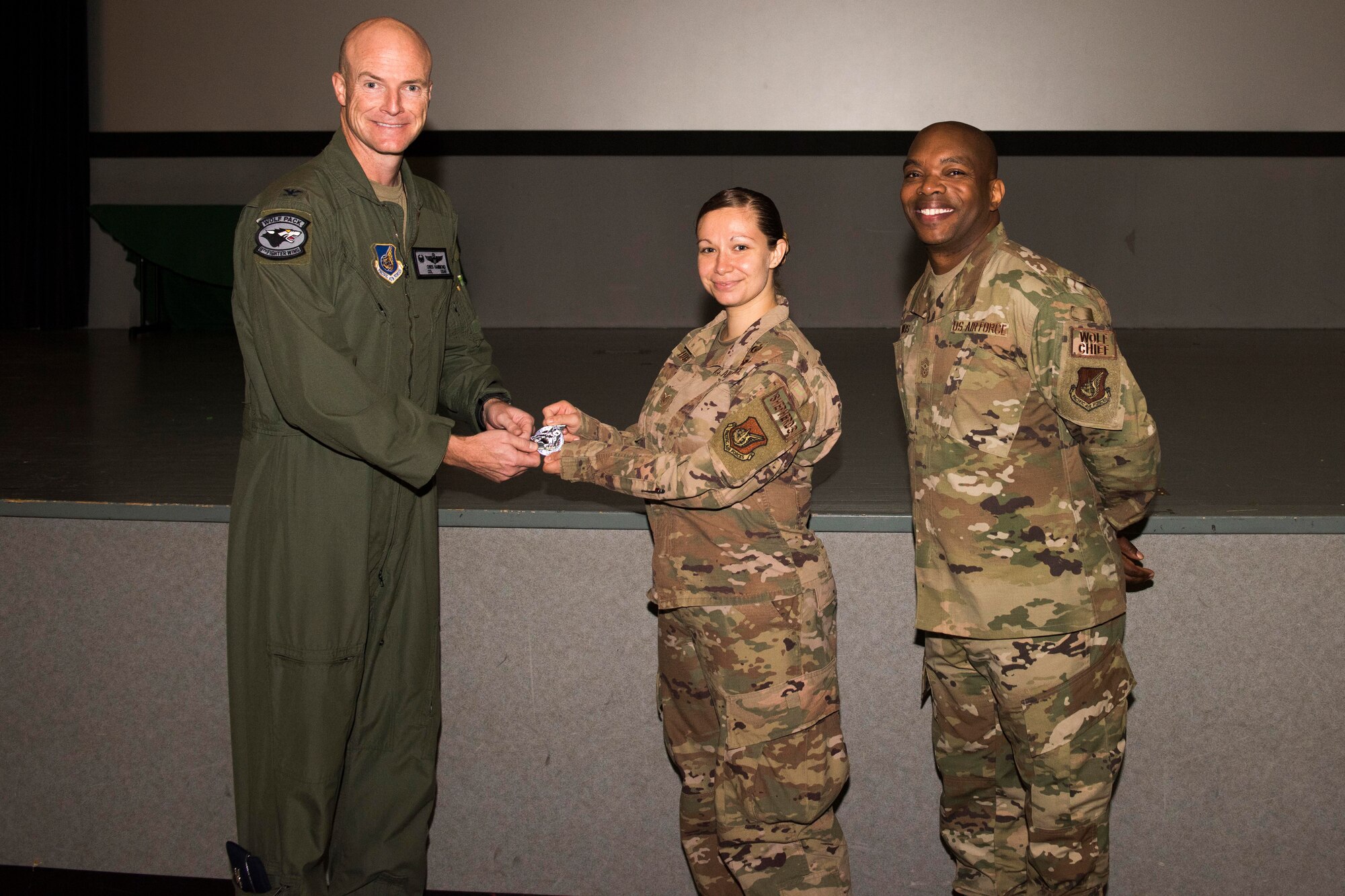 A photo of an Airman being coined.