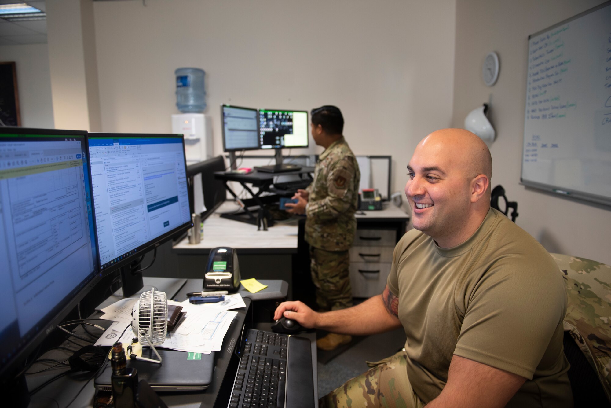 Photo of an Airman working at his desk.