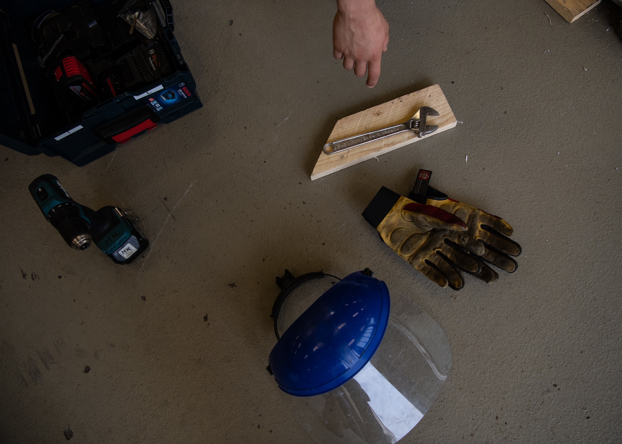 U.S. Air Force Airman 1st Class Tyler Sellitto, 786th Civil Engineer Squadron structural journeyman, reaches for a wrench while constructing a bio containment unit ramp at Ramstein Air Base, Germany, Aug. 10, 2020.