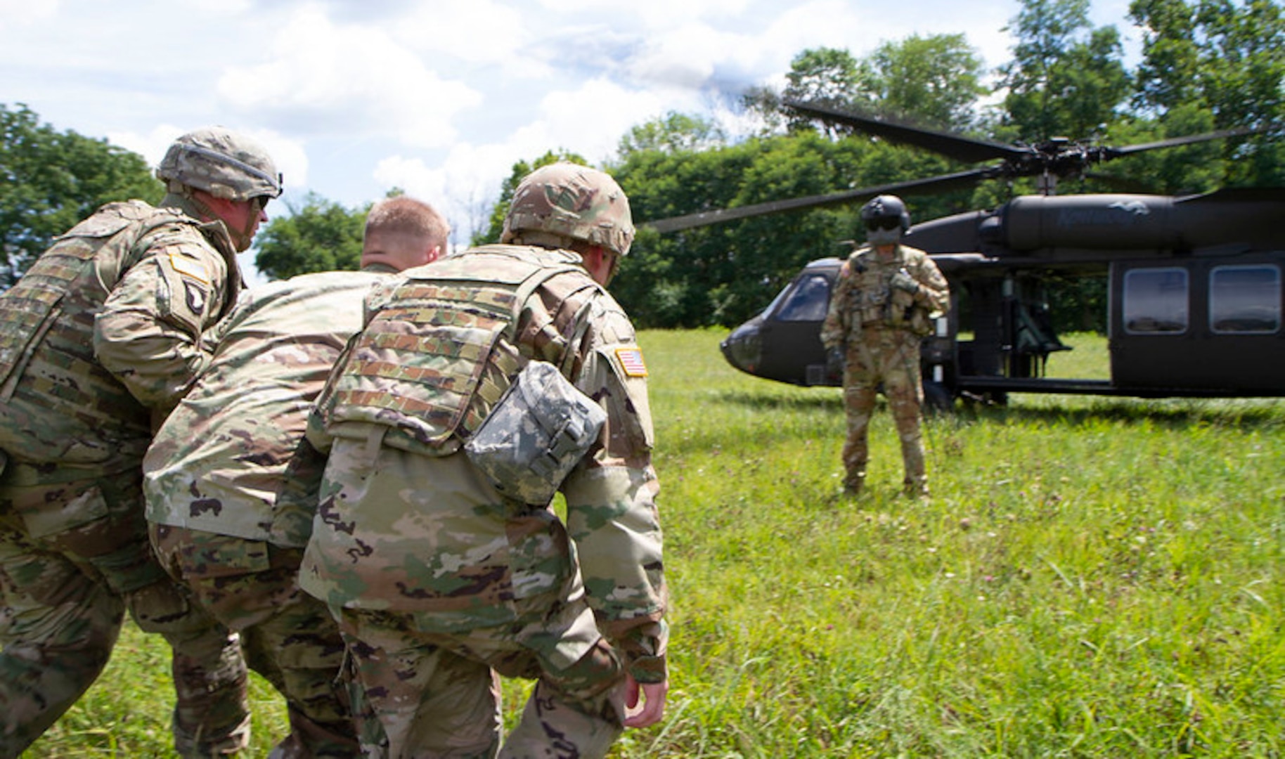 Kentucky National Guard Soldiers with the 617th Military Police Company help a simulated injured person to a UH-60 Black Hawk helicopter during casualty evacuation training at Blue Grass Army Depot in Richmond, Ky., Aug. 12, 2020.