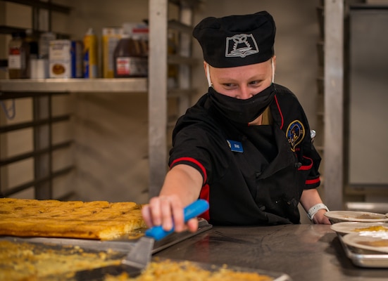Culinary Specialist Seaman Mary Brians, a native of Tulsa, Okla., prepares dinner in the galley aboard Nimitz-class nuclear aircraft carrier USS Carl Vinson (CVN 70).