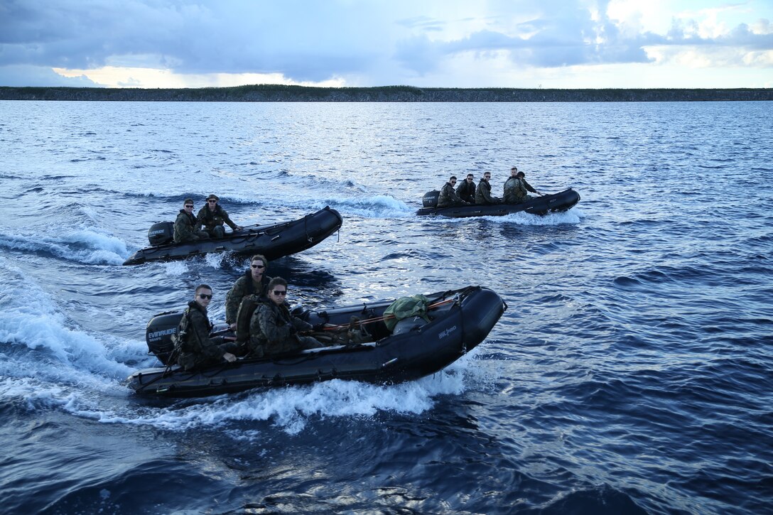 Marines from Alpha Company, 3d Recon Battalion, 3d Marine Division ride Combat Rubber Raiding Crafts (CRRC's) during a joint training exercise on Naval Base Guam, July 22, 2019.