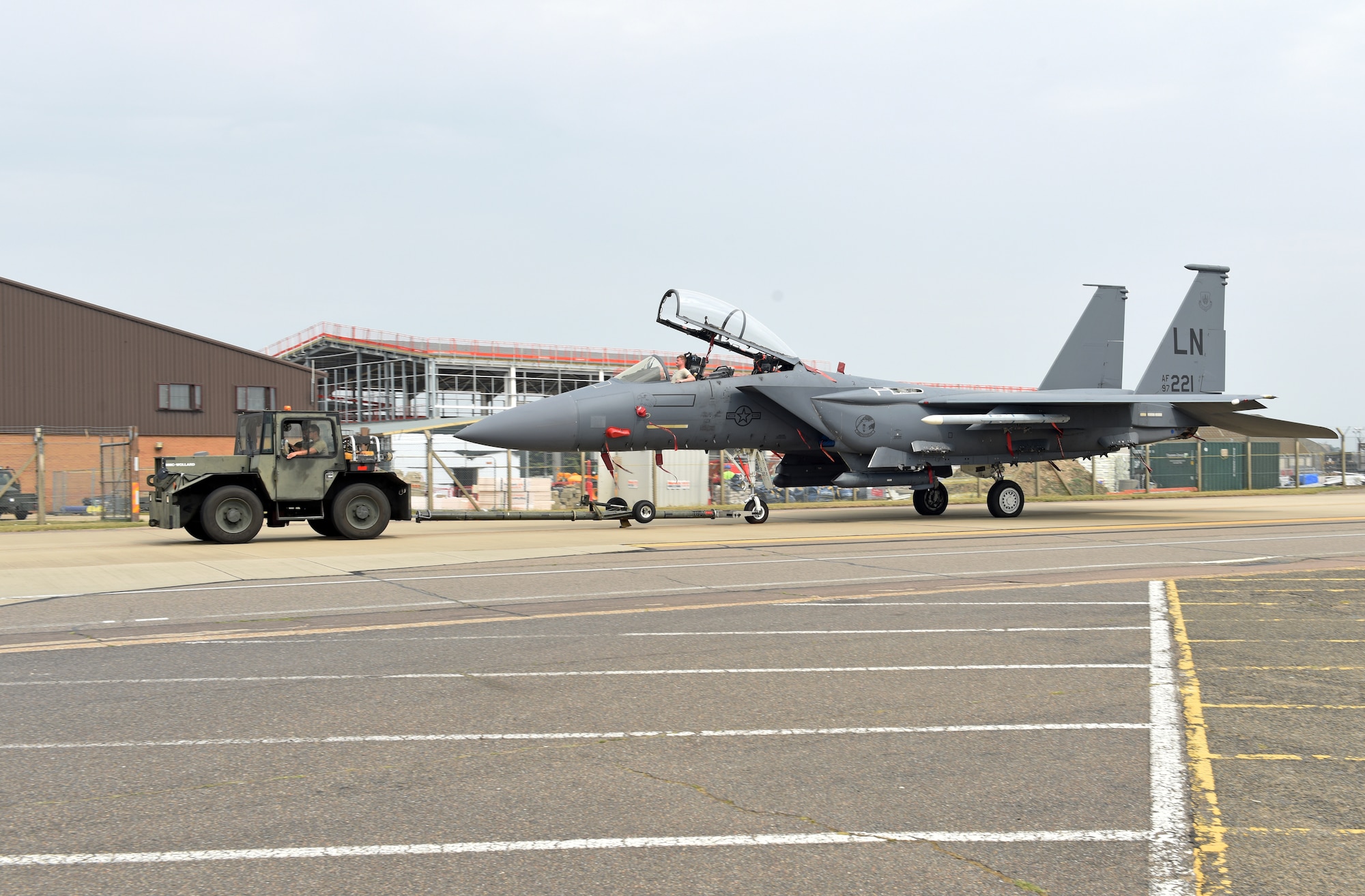 An F-15E Strike Eagle assigned to the 48th Fighter Wing is moved to the newly expanded parking ramp at Royal Air Force Lakenheath, England, Aug. 11, 2020. The ramp’s completion signified another key milestone as the 48th Fighter Wing prepares to welcome its first F-35A aircraft in late 2021. (U.S. Air Force photo by Airman 1st Class Rhonda Smith)