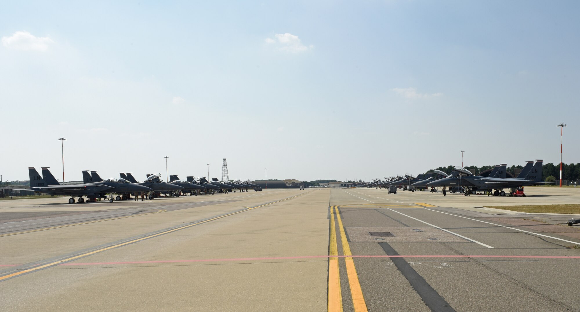 A fleet of F-15E Strike Eagles from the 492nd Fighter Squadron and the 494th FS utilizes the newly expanded ramp at Royal Air Force Lakenheath, England, Aug. 12, 2020. The ramp consolidates F-15E Strike Eagle operations for the two squadrons, shortens transit times and maintenance operations, and improves mission efficiency.  (U.S. Air Force photo by Airman 1st Class Rhonda Smith)