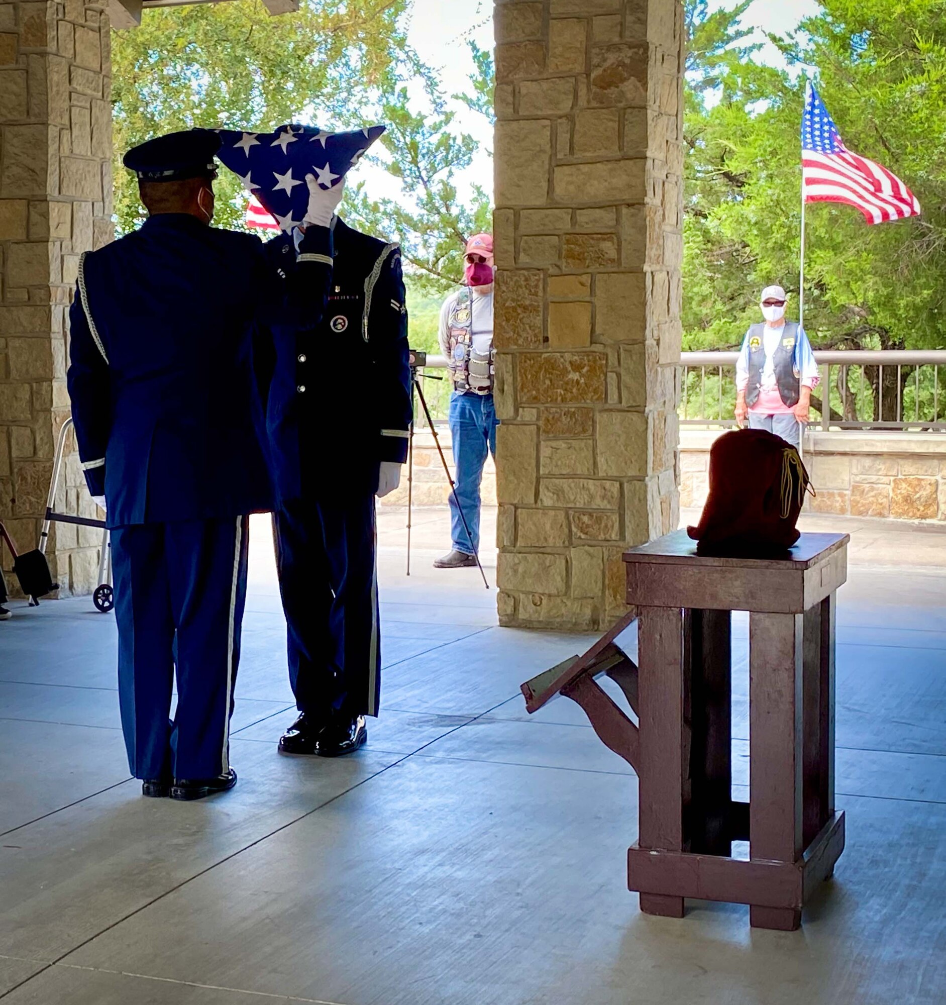 Airmen from the Dyess Air Force Base Honor Guard prepare a memorial flag for POW and F-16 program founder, Brigadier General Lyle Cameron's wife on August 7 during a funeral ceremony at Dallas Fort Worth National Cemetery. Before his contributions to the F-16 program, Brig. Gen. Cameron was held captive for 32 months at a prisoner of war camp in Mukden (Shenyang), China. (U.S. Air Force photo by Capt. Jessica Gross)