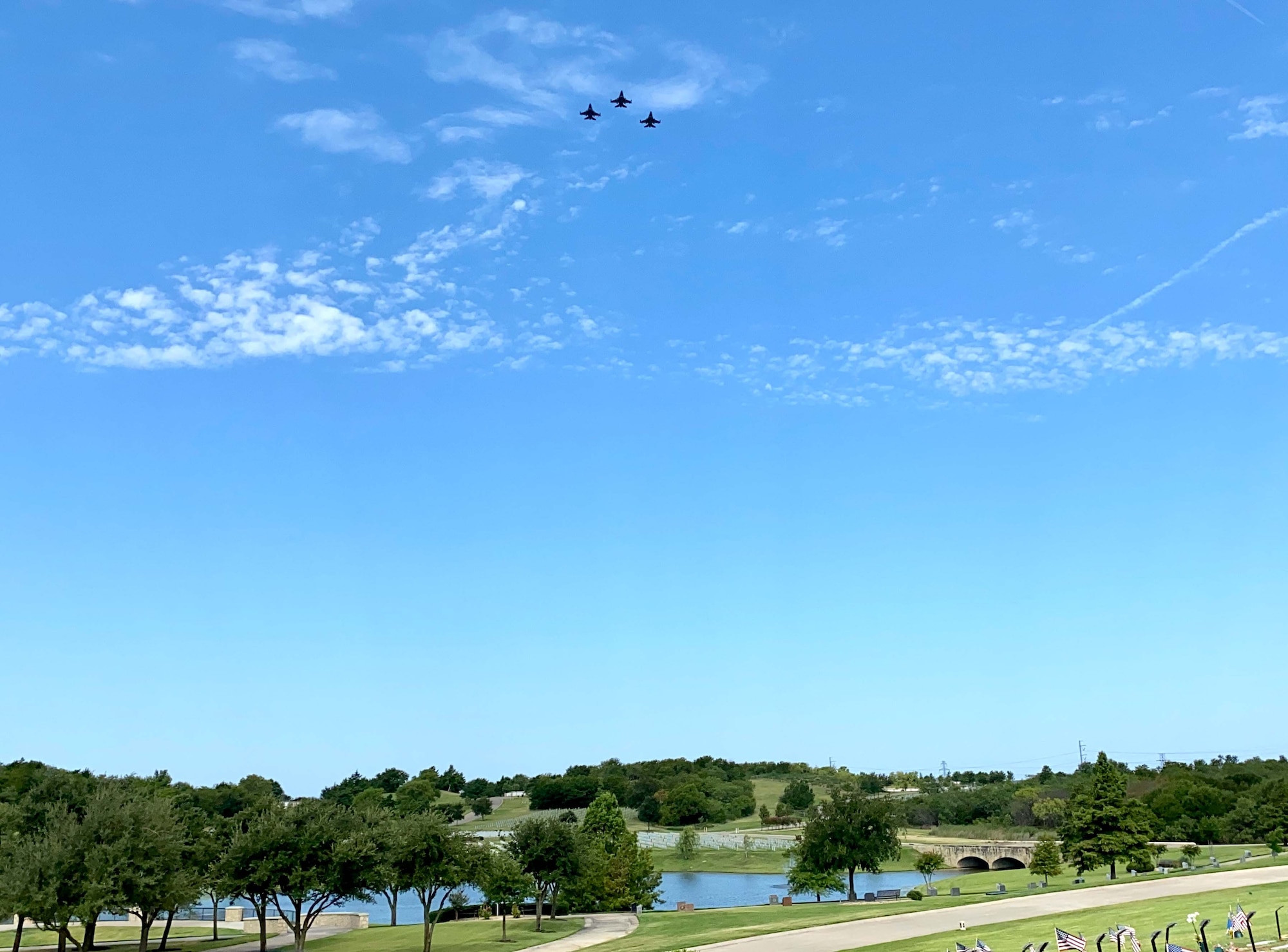 F-16 pilots assigned to the 457th Fighter Squadron, 301st Fighter Wing, performed a memorial flyover at Dallas Fort Worth National Cemetery to honor POW and F-16 program founder, Brigadier General Lyle Cameron on August 7. They flew a "missing man” formation flyover for his remaining family members, friends and those in attendance. (U.S. Air Force photo by Capt. Jessica Gross)