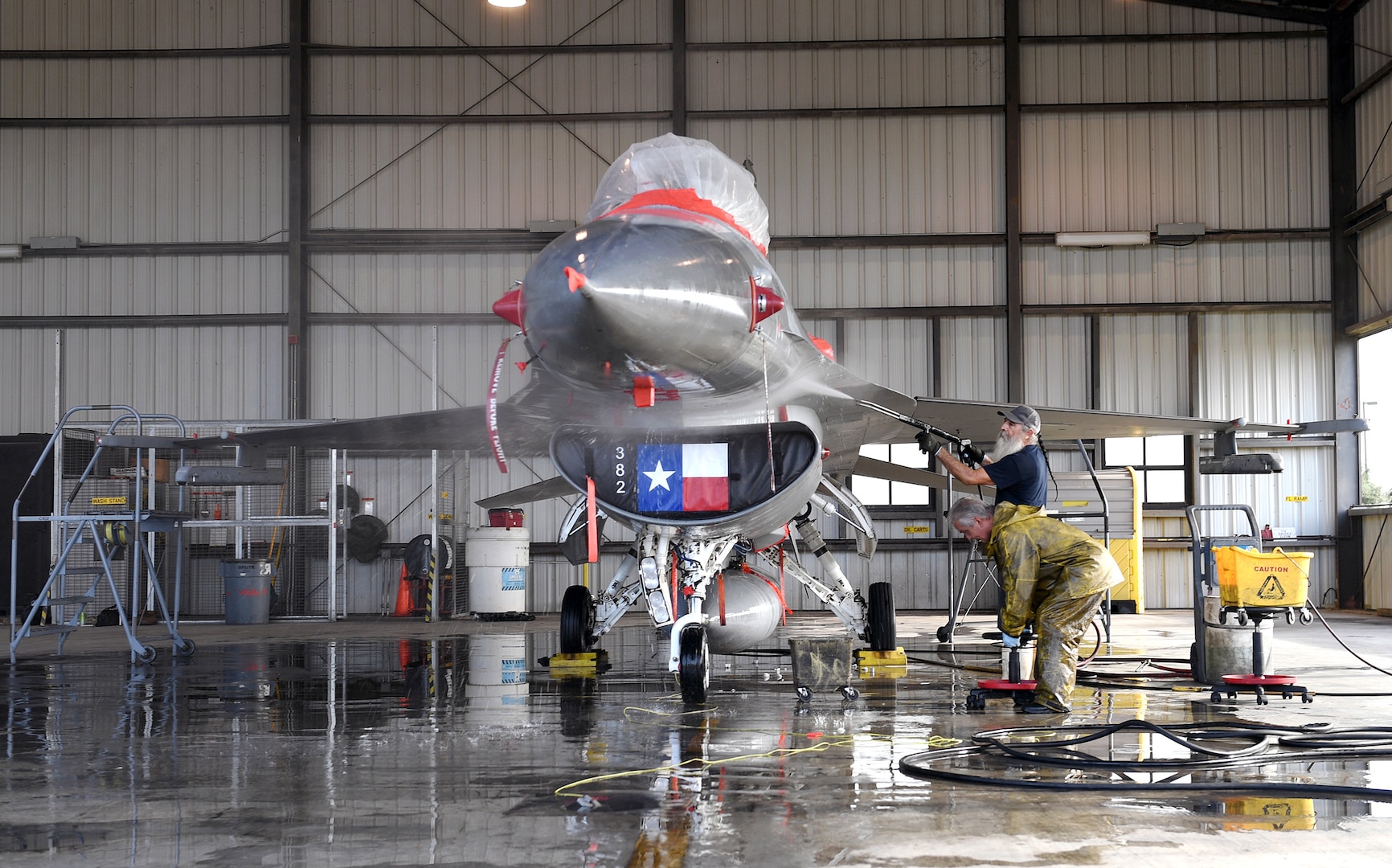 An F-16 Fighting Falcon, assigned to the Air National Guard's 149th Fighter Wing, receives a jet wash at Joint Base San Antonio-Lackland July 24.