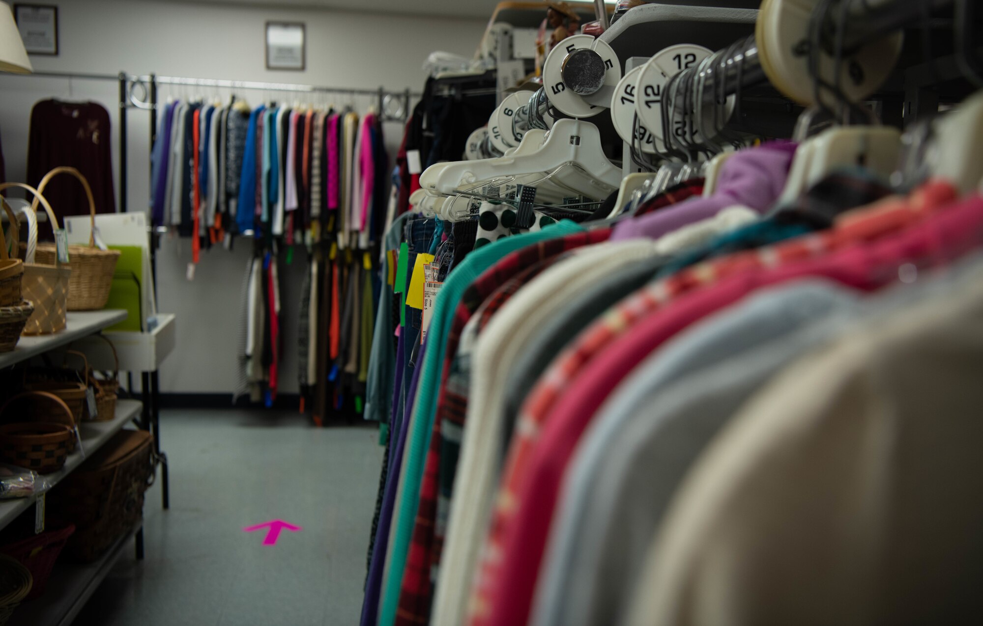 Racks of clothing in a thrift shop.