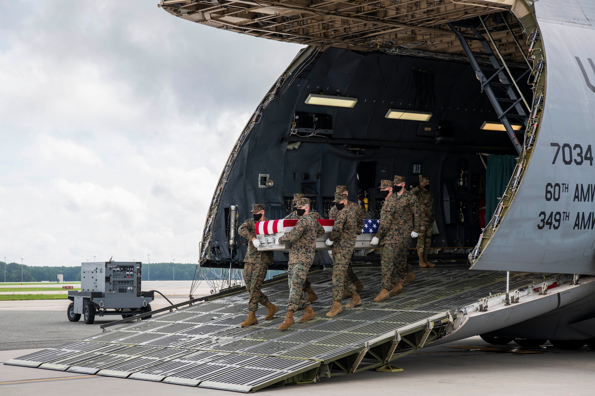 A U.S. Marine Corps carry team transfers the remains of Sgt. Trevor M. Goldyn, of Frankfort, Illinois during a dignified transfer Aug. 14, 2020, at Dover Air Force Base, Delaware. Goldyn was assigned to 5th Marine Expeditionary Brigade, Marine Forces Central Command, Bahrain.