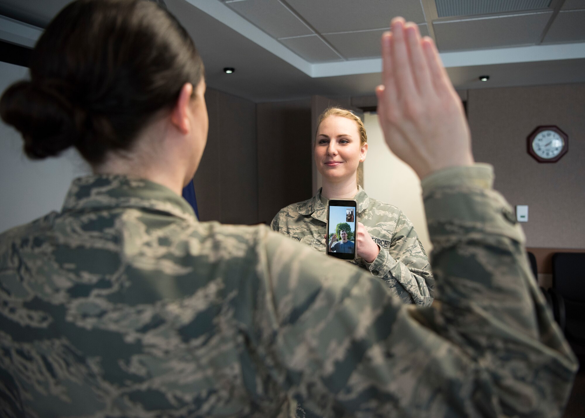 Staff Sgt. Elysia Wilson, 168th Wing production recruiter, helps enlist a new recruit using a video conference call April 16, 2020, at Eielson Air Force Base, Alaska. This virtual enlistment allowed a new Alaska Air National Guard recruit to complete their oath of enlistment while complying with COVID-19 safety regulations. (U.S. Air National Guard photo by Senior Airman Shannon Chace)