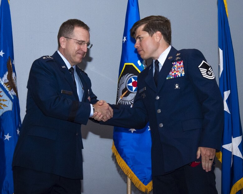 image of Master sergeant john grimesey receiving silver star medal from lieutenant general jim slife