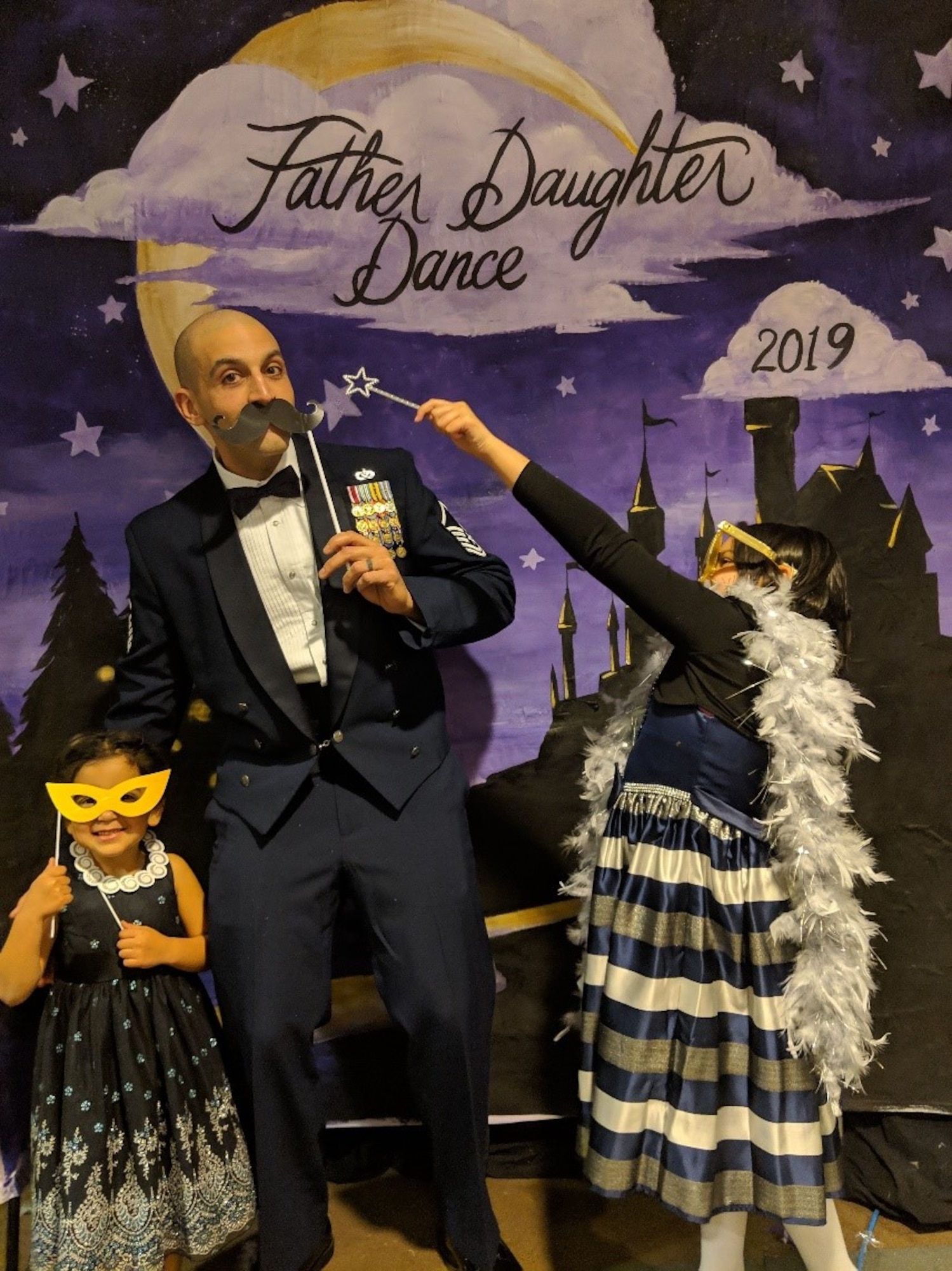 Master Sgt. Ya’acov Mosly, 21st Civil Engineering Squadron operations of engineering section chief and his daughters Emma, 10 and Lilly, 5 pose for a funny photo at Peterson Air Force Base, 2019.