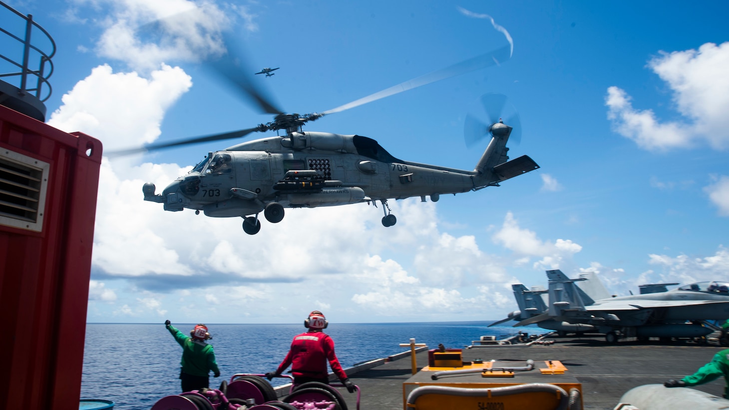 200814-N-KP021-0220 SOUTH CHINA SEA (August 14, 2020) An MH-60R Seahawk assigned to the “Saberhawks” of Helicopter Maritime Strike Squadron (HSM) 77 lifts off the flight deck of America’s only forward-deployed aircraft carrier USS Ronald Reagan (CVN 76)  while conducting operations in the South China Sea. Ronald Reagan, the flagship of Carrier Strike Group 5, provides a combat-ready force that protects and defends the United States, as well the collective maritime interests of its allies and partners in the Indo-Pacific region. (U.S. Navy photo by Mass Communication Specialist 2nd Class Codie L. Soule)