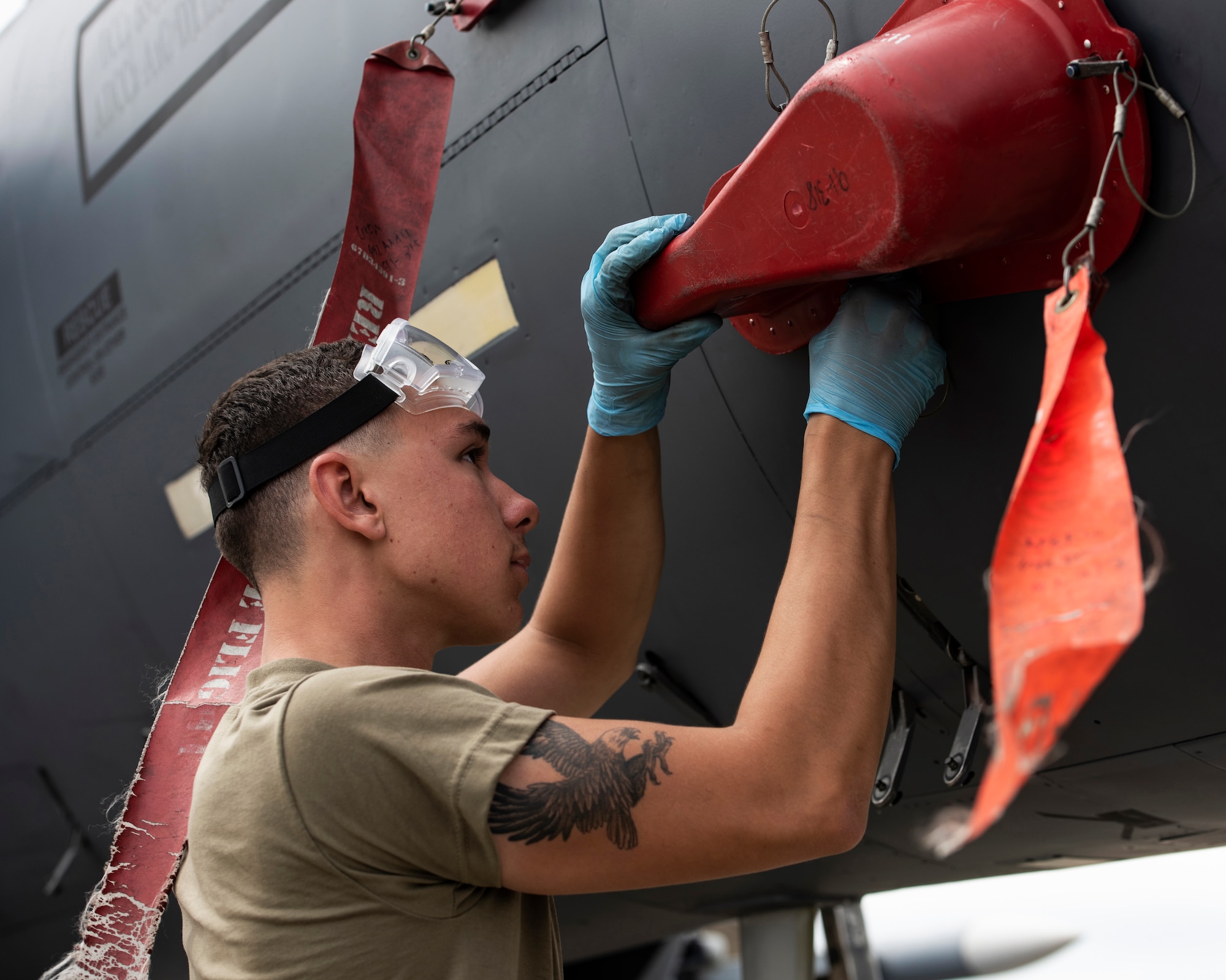 U.S. Air Force Airman 1st Class Wyatt Cresswell, 492nd Aircraft Maintenance Unit crew chief, replaces the covers on an F-15E Strike Eagle at Royal Air Force Lakenheath, England, July 23, 2020. 48th AMXS Airmen ensure Liberty Wing F-15s are fit to fly and can continue to provide superior airpower capabilities when called upon. (U.S. Air Force photo by Airman 1st Class Jessi Monte)