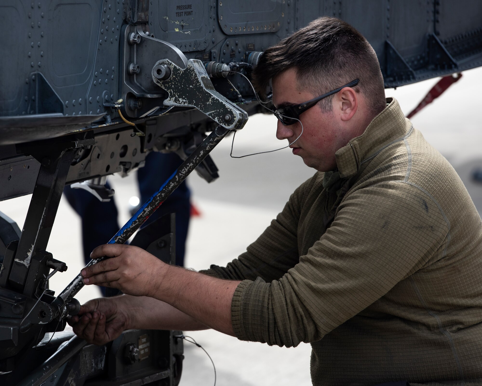 U.S. Air Force Senior Airman Zachery Larson, 48th Aircraft Maintenance Squadron crew chief, conducts a routine service on an F-15E Strike Eagle conformal fuel tank at Royal Air Force Lakenheath, England, July 24, 2020. 48th AMXS Airmen ensure Liberty Wing F-15s are fit to fly and can continue to provide superior airpower capabilities when called upon. (U.S. Air Force photo by Airman 1st Class Jessi Monte)