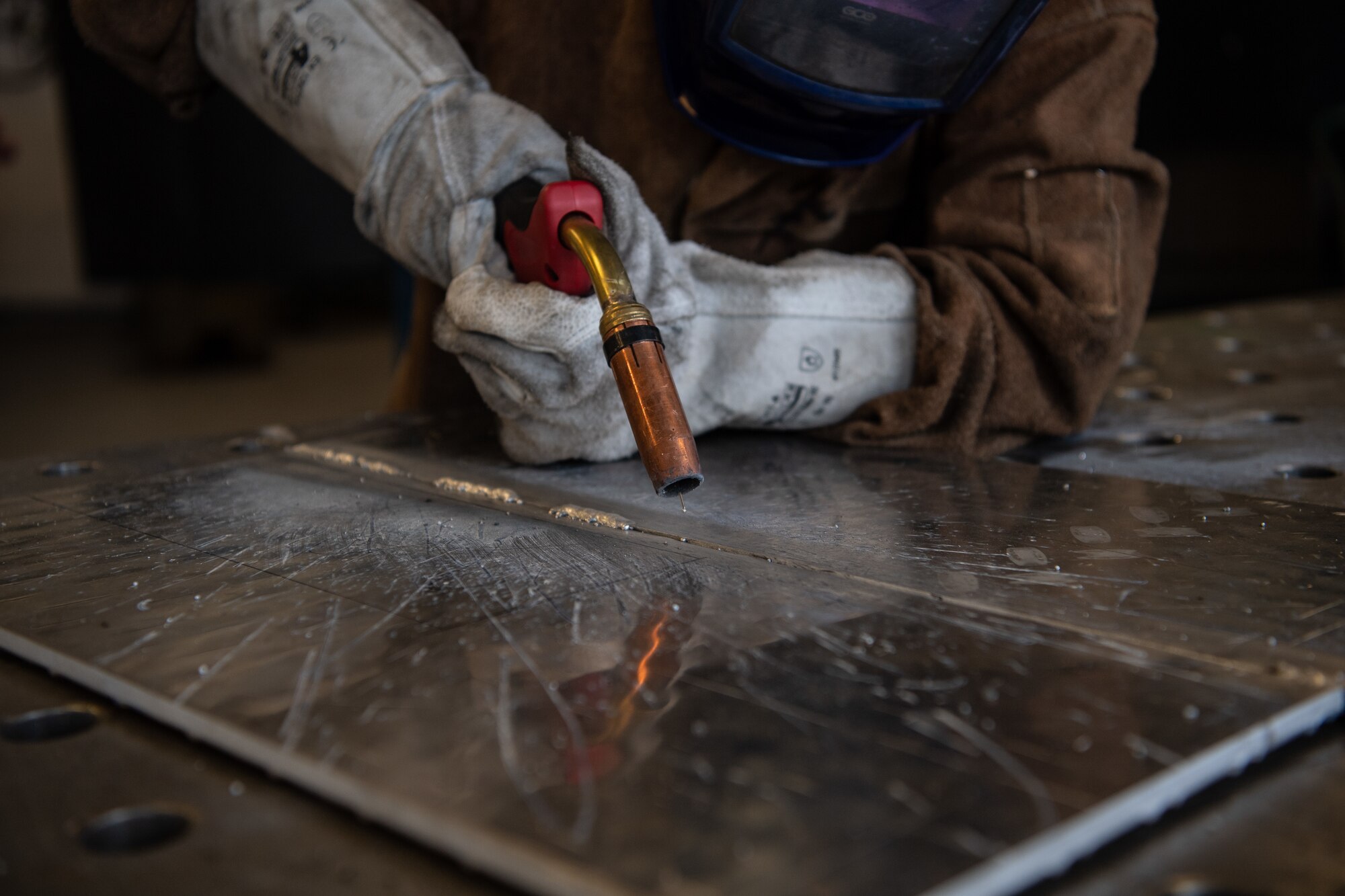 U.S. Air Force Airman 1st Class Austen Campbell, 786th Civil Engineer Squadron structural journeyman, prepares to weld a piece for a bio containment unit ramp at Ramstein Air Base, Germany, Aug. 10, 2020.