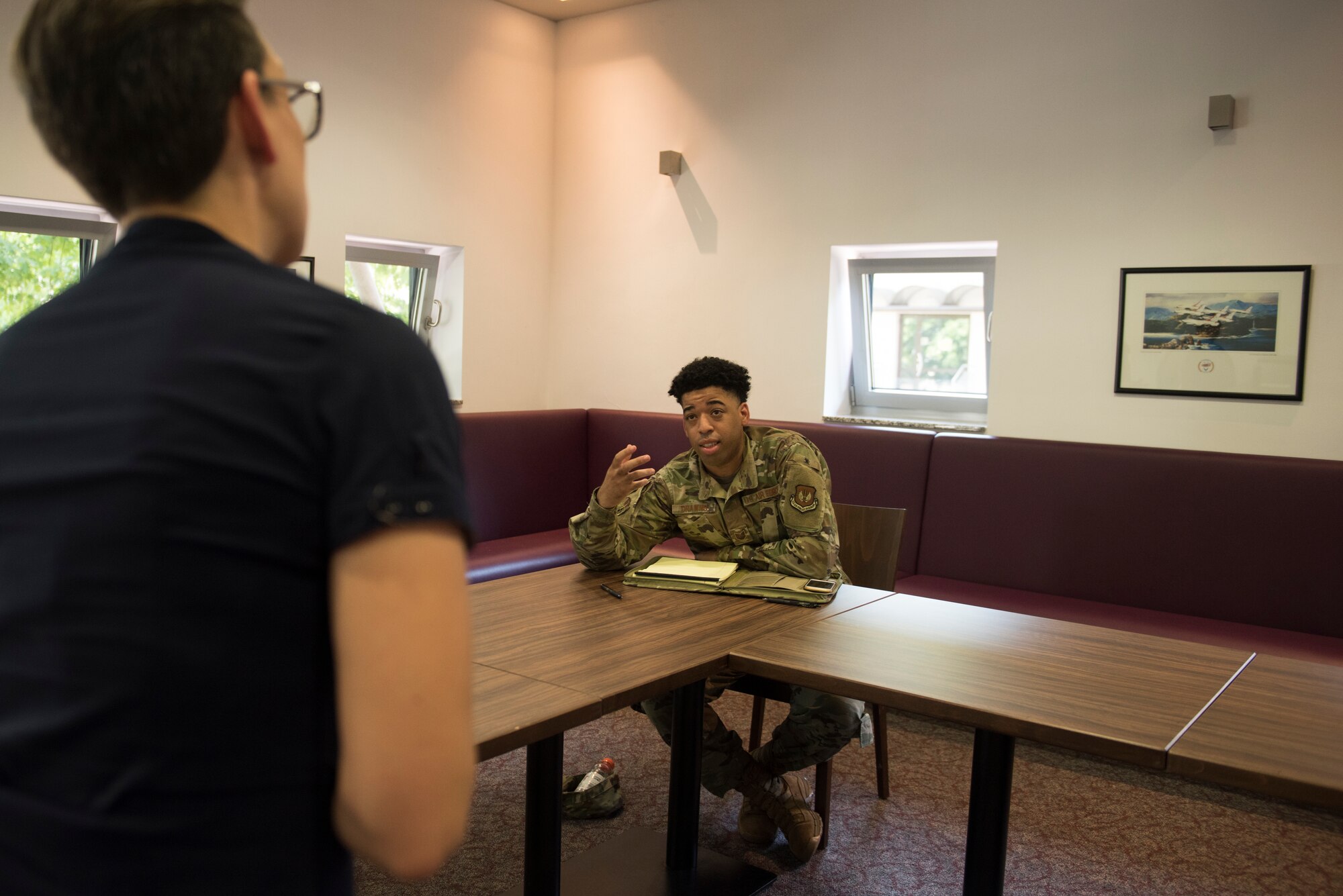 An Airman speaks to a teacher.