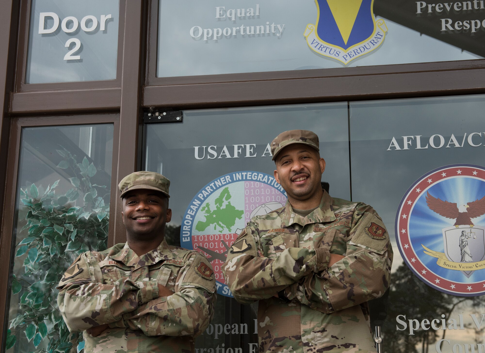 Two Airmen pose for a photo.