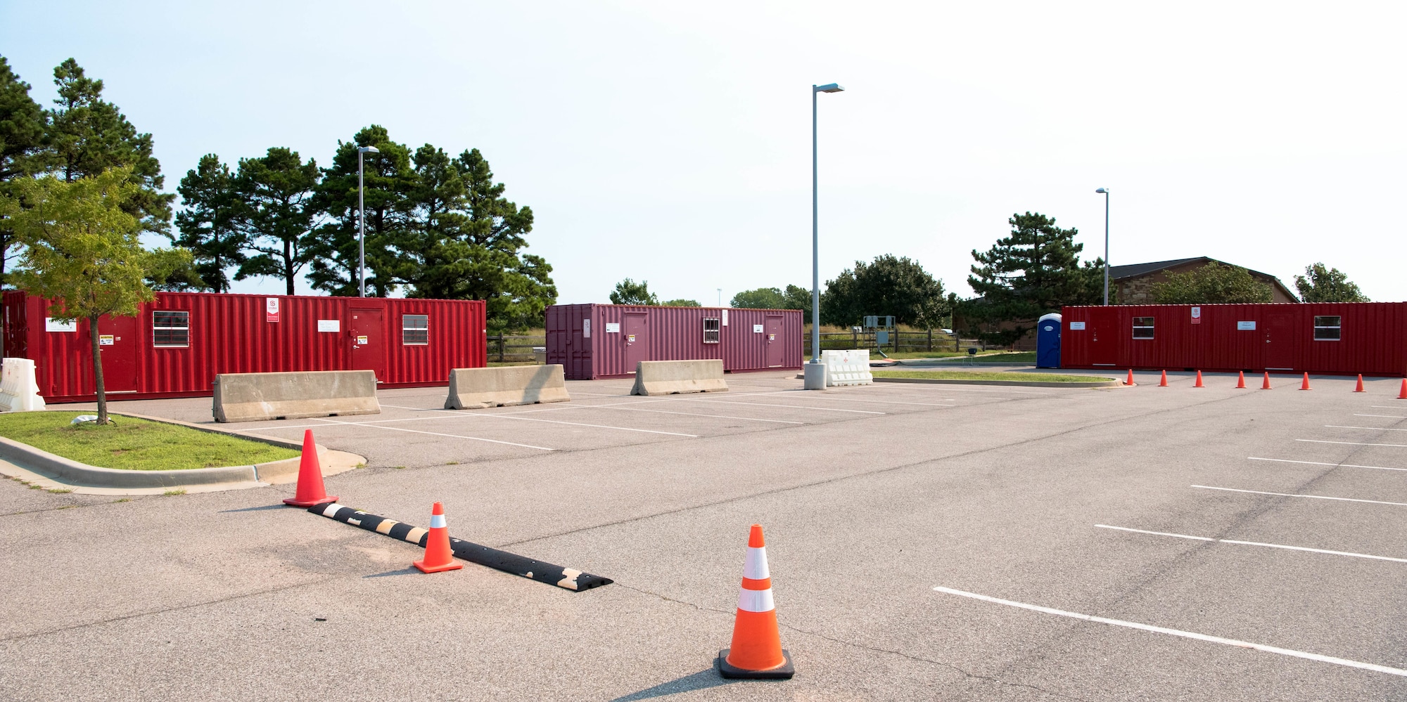 Three temporary buildings in parking lot of clinic.