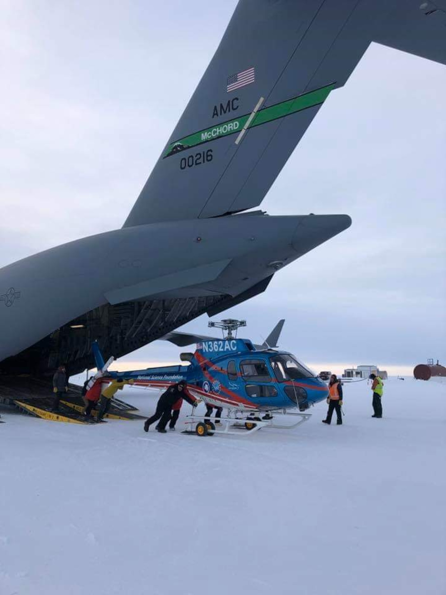Loadmasters from the 62nd Airlift Wing work with U.S. Antarctic Program cargo handlers to offload a National Science Foundation helicopter on Phoenix Airfield, Antarctica, in this February 2019 file photo. Airmen from Joint Base Lewis-McChord deploy annually as the 304th Air Expeditionary Squadron to Antarctica to deliver people and supplies to the McMurdo scientific research station. (Courtesy photo by Lt. Col. Brandon Tellez)