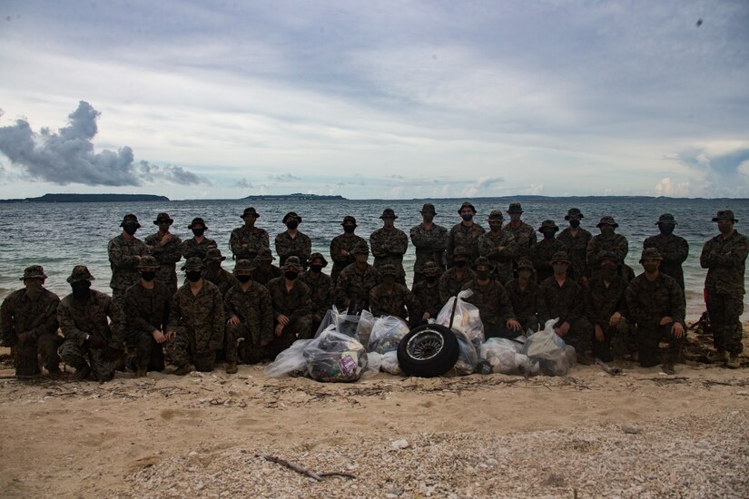 Marines pose for a group photo following a beach cleanup.