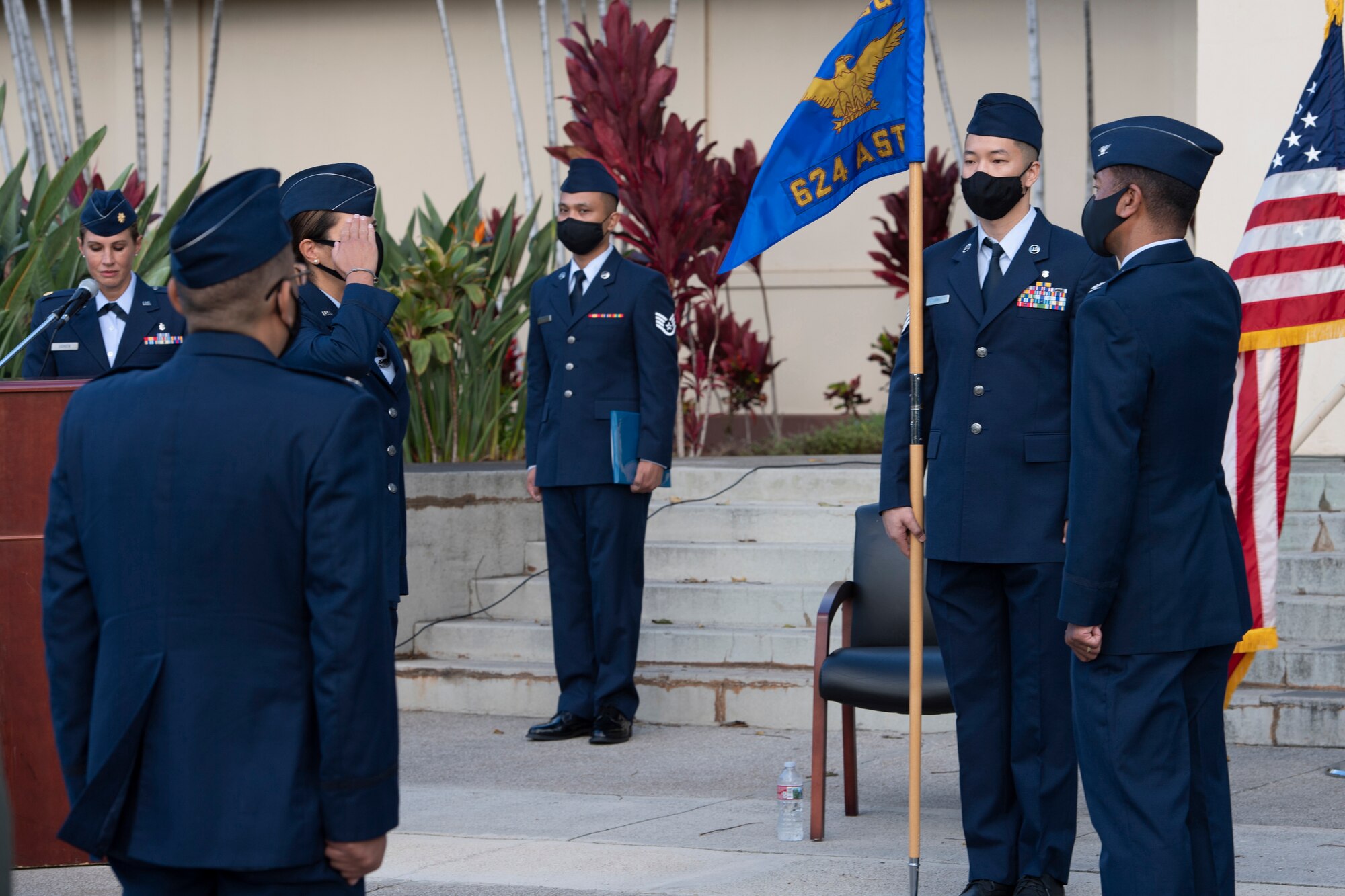 A photo of U.S. Air Force Col. Athanasia Shinas, 624th Regional Support Group commander, returning a salute from Col. Edward Johnson, 624th Aeromedical Staging Squadron incoming commander, as he takes command during the 624th ASTS change of command ceremony in front of the 15th Medical Group building at Joint Base Pearl Harbor-Hickam, Hawaii, Aug. 8, 2020.