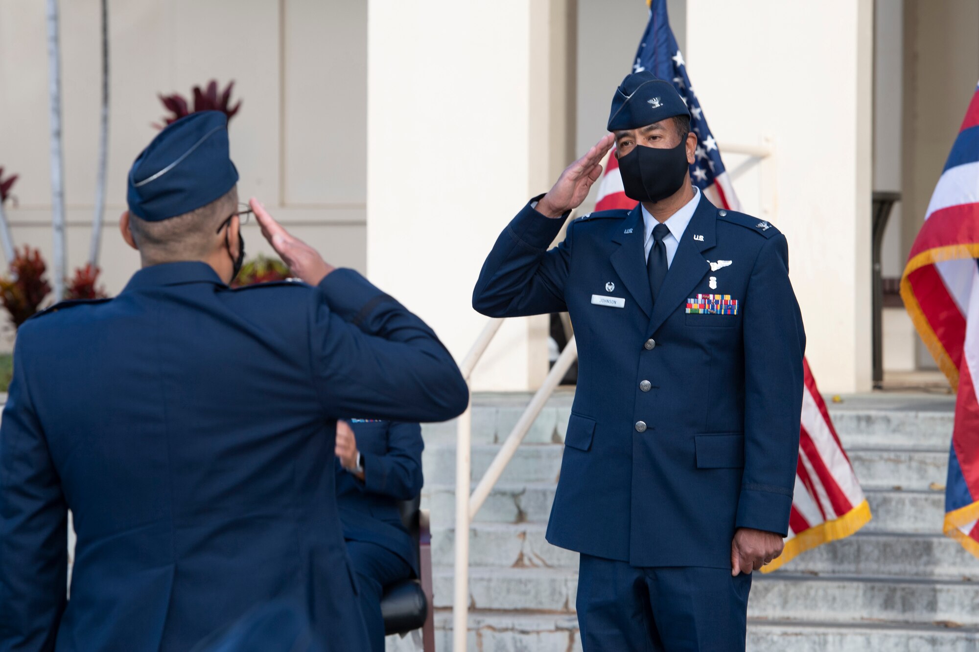 A photo of U.S. Air Force Col. Edward Johnson, receiving his first salute as the 624th Aeromedical Staging Squadron commander from Lt. Col. Regan Ramos, 624th ASTS chief of nursing services, during the 624th ASTS change of command ceremony in front of the 15th Medical Group building at Joint Base Pearl Harbor-Hickam, Hawaii, Aug. 8, 2020.