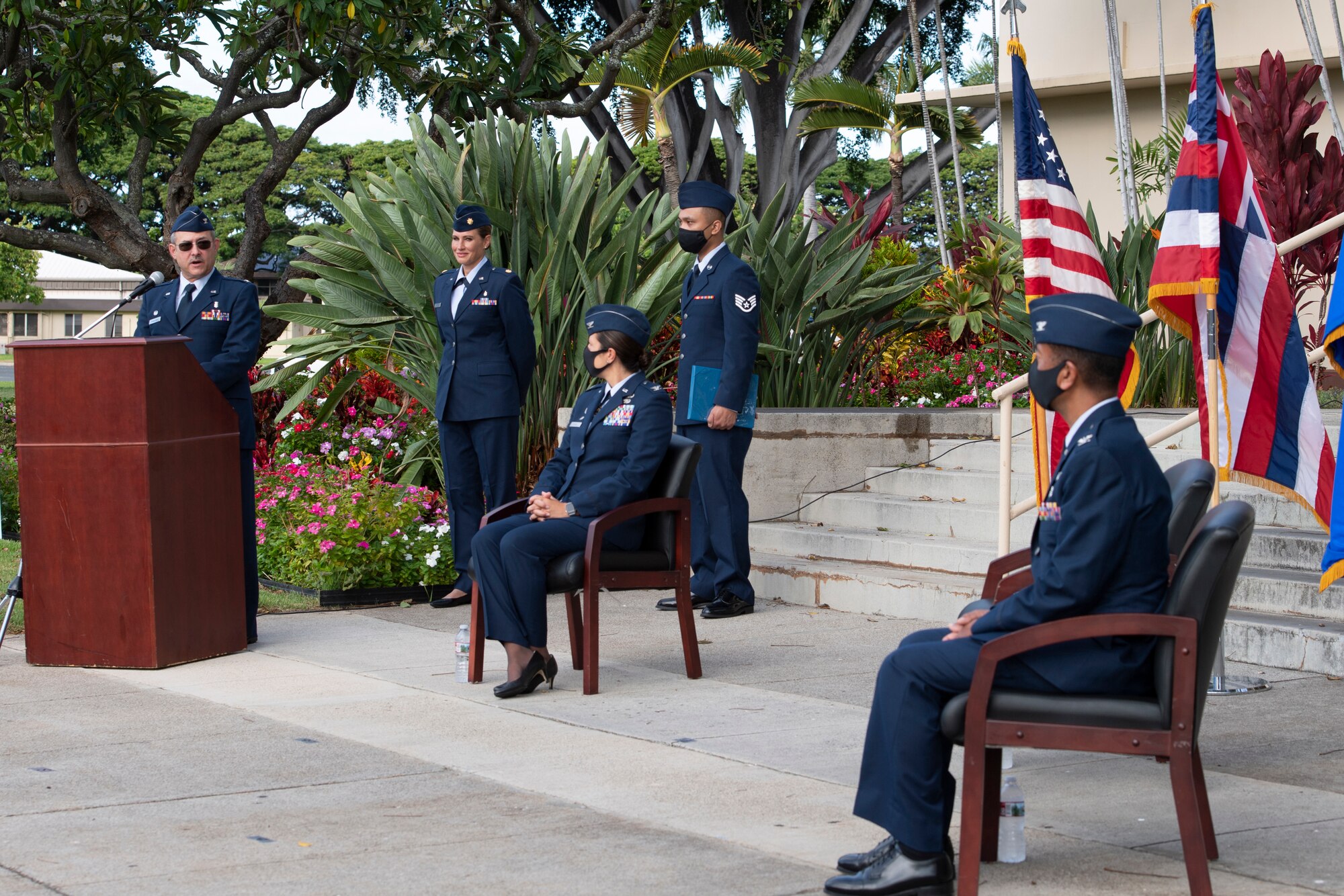 A photo of U.S. Air Force Col. Lee Bradshaw, 624th Aeromedical Staging Squadron outgoing commander, speaking to audience members during the 624th ASTS change of command ceremony in front of the 15th Medical Group building at Joint Base Pearl Harbor-Hickam, Hawaii, Aug. 8, 2020.