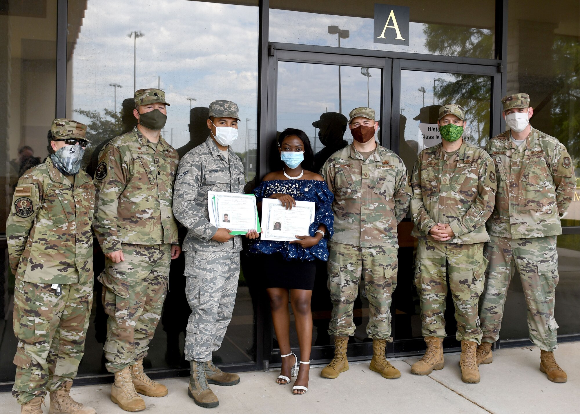 Airman 1st Class Edgar Barcenas Zumaya, 22nd Civil Engineer Squadron, water and fuel systems maintenance apprentice, poses for a photo with proof of citizenship after a naturalization ceremony Aug. 7, 2020 at Wichita State University, Wichita, Kansas. Barcenas Zumaya was joined by 50 people, representing 10 other countries around the globe, who also became U.S. citizens during the ceremony. (U.S. Air Force photo by Tech. Sgt. Jennifer Stai)