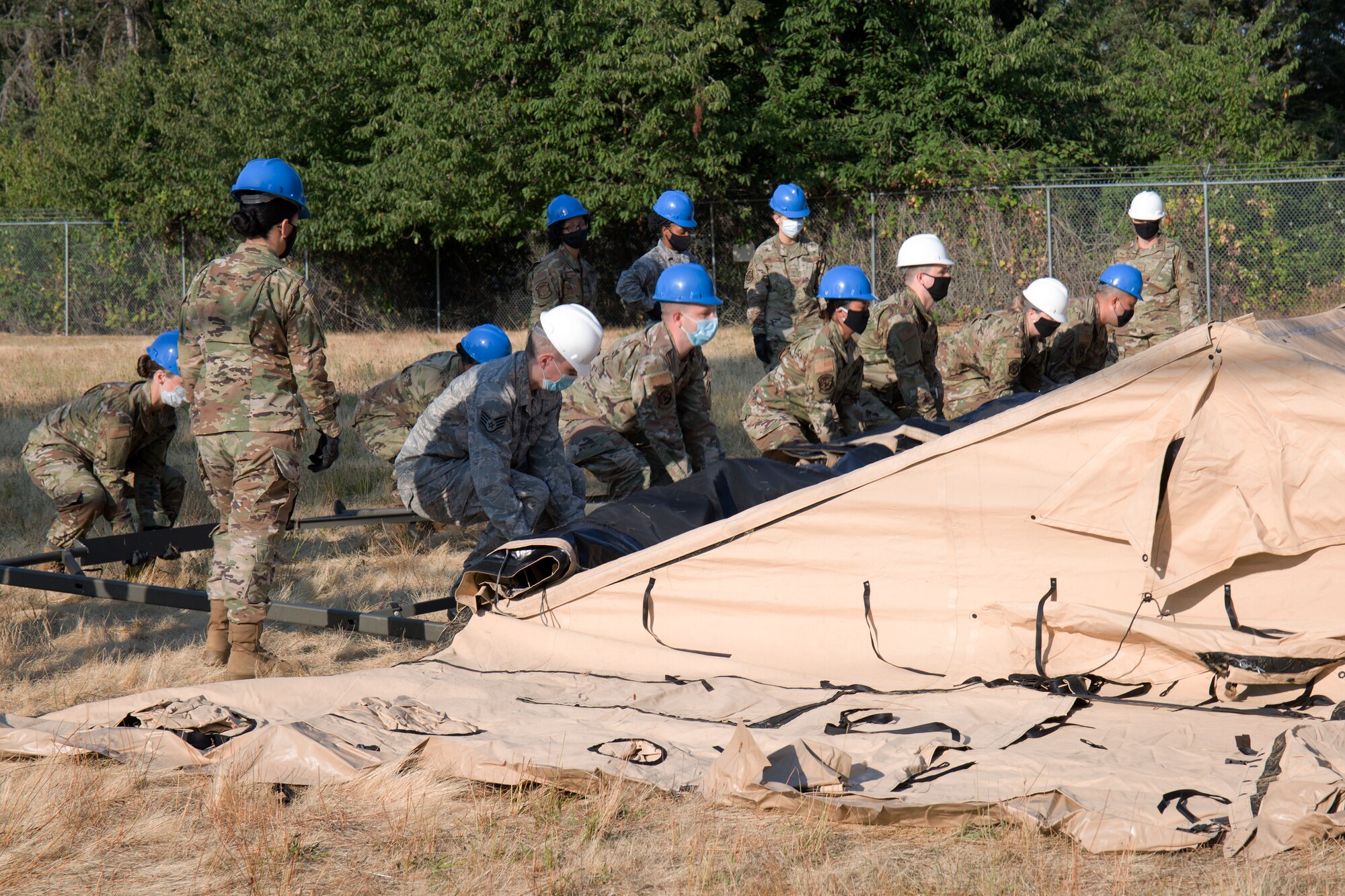 Airmen hoist up a field kitchen.