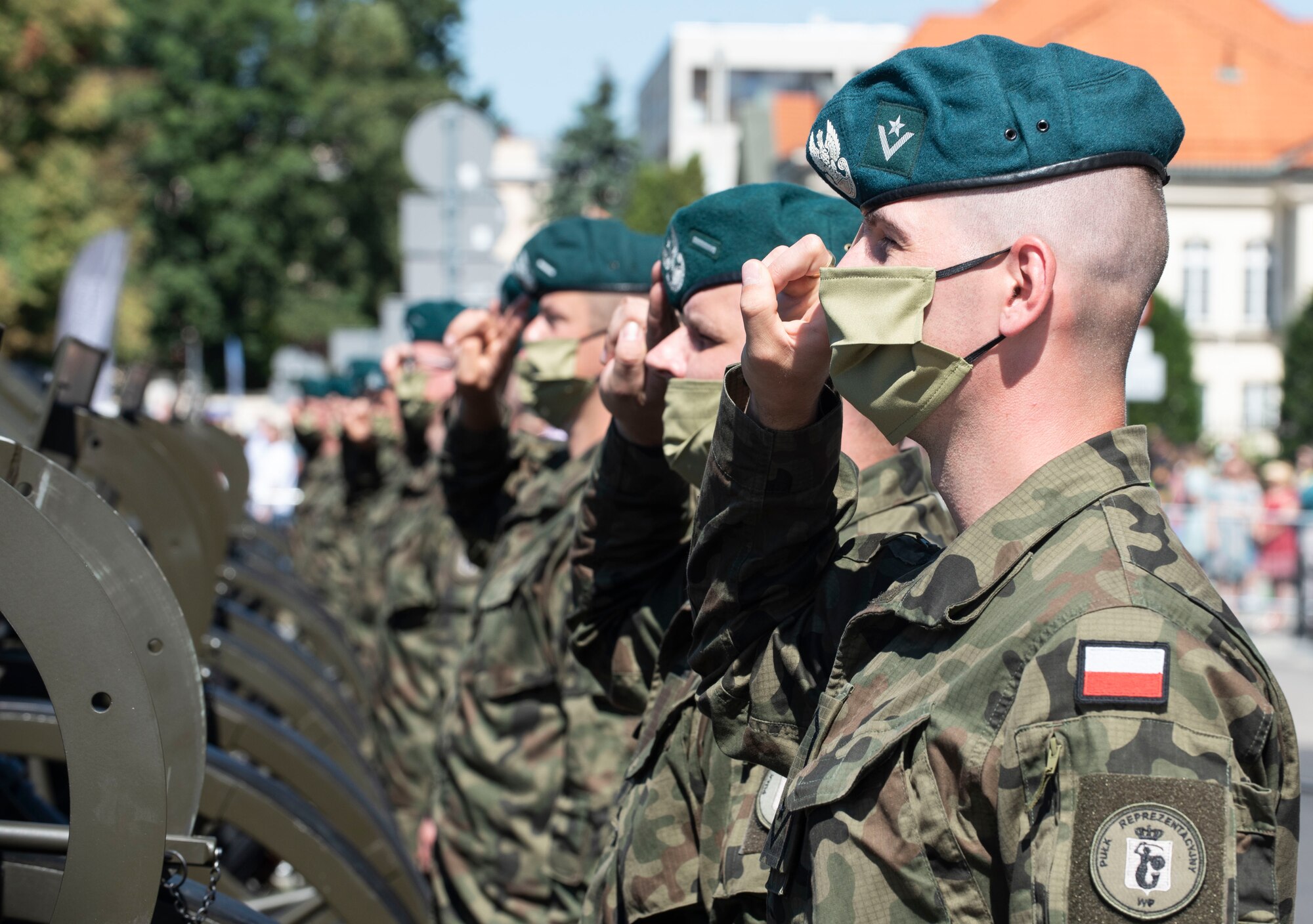 Polish service members salute during the Polish national anthem at Warsaw, Poland, August 15, 2020. Poland commemorates the 100th anniversary of the Battle of Warsaw, a Polish victory in the Polish-Soviet War, during this year’s Polish Armed Forces Day. (U.S. Air Force photo by Senior Airman Melody W. Howley)