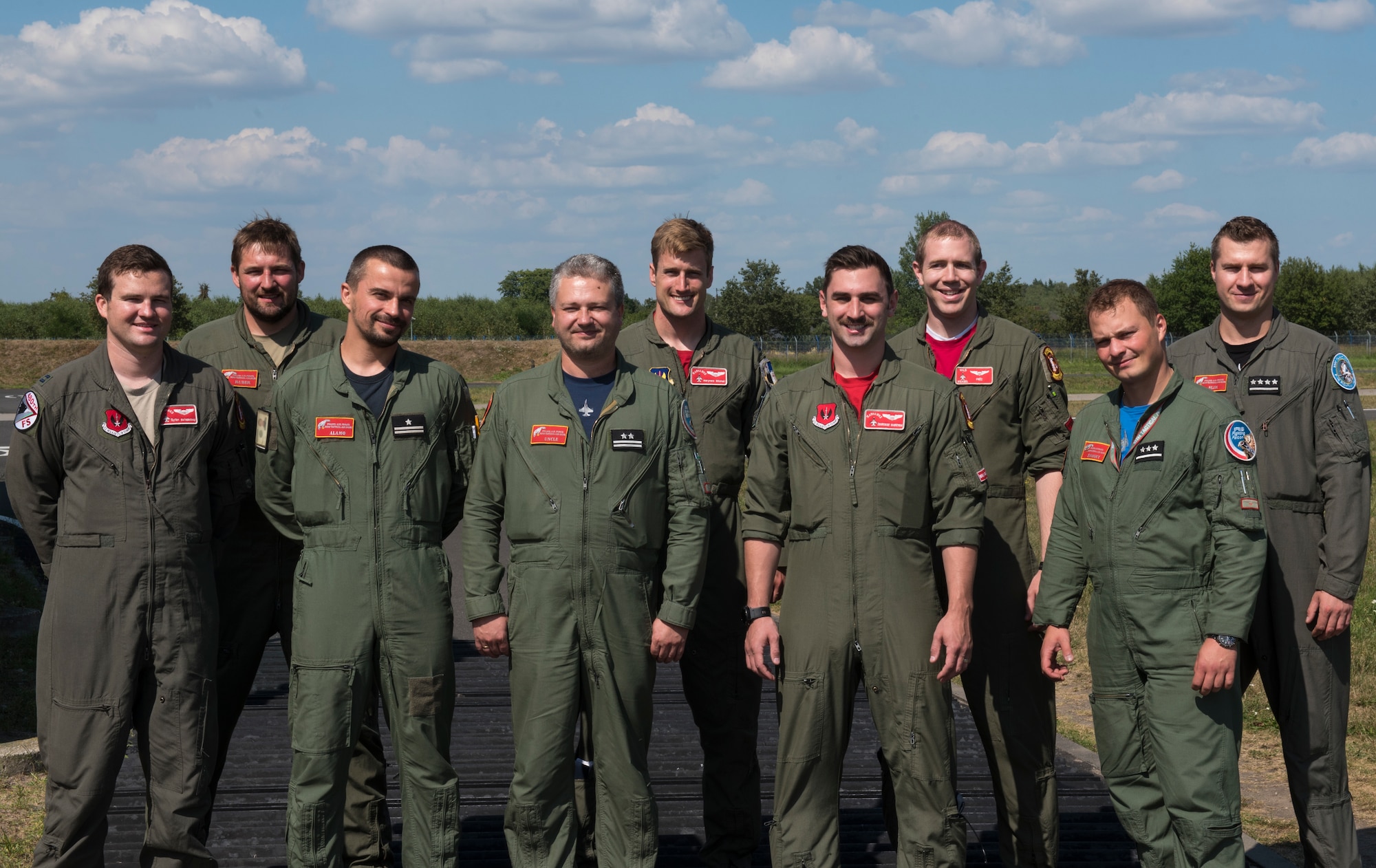 U.S. Air Force and Polish air force F-16 pilots gather for a group photo at Lask Air Base, Poland, August 15, 2020. The pilots flew over Warsaw, Poland to support Polish Armed Forces Day, a celebration of the 100th Anniversary of Poland's victory during the Polish-Soviet War. (U.S. Air Force photo by Senior Airman Chanceler Nardone)