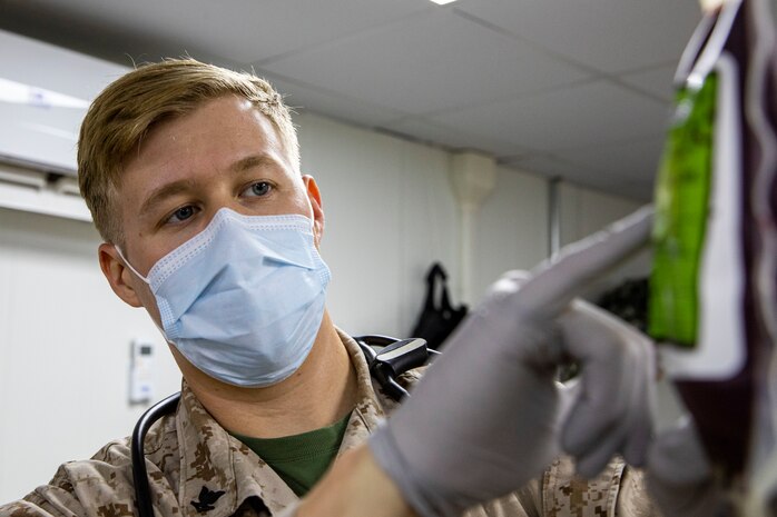 A U.S. Navy Hospital Corpsman verifies a donor’s information on a unit of blood during an Emergency Whole Blood Transfusion Training Program in Kuwait, July 30.