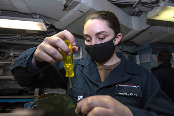 Aviation Electronics Technician Airman Kaleigh Fuchs, from New Haven, Connecticut, performs maintenance on an infrared targeting system in the aviation electrical optics shop of the Navy’s only forward-deployed aircraft carrier USS Ronald Reagan (CVN 76).