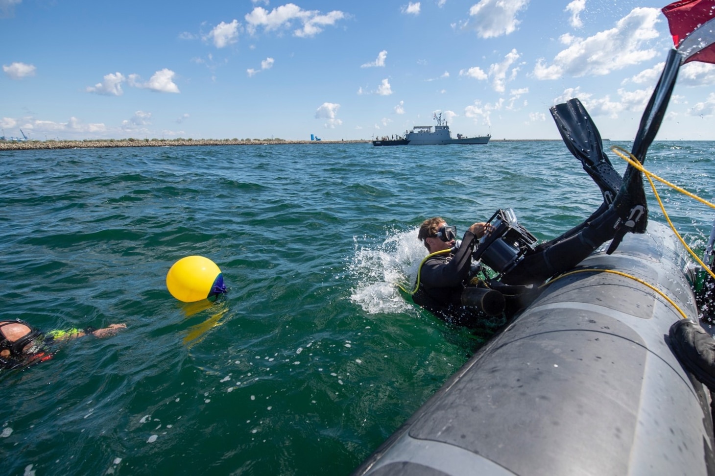 200805-N-RH019-0016 CONSTANTA, Romania, (Aug. 5, 2020) United States Navy Explosive Ordinance Disposal (EOD) Technician Dive Supervisor, of EOD Mobile Unit 8, controls the tending line as the diver conducts a backwards roll into Black Sea during Eurasian Partnership Mine Countermeasures (EP MCM) 2020, August 5,2020. EPMCM is a multi-lateral engagement with U.S., Romanian and Bulgarian forces, focused on enhancing mine countermeasure operations in the Black Sea, while strengthening interoperability between allied forces. U.S. 6th Fleet, headquartered in Naples, Italy, conducts the full spectrum of joint and naval operations, often in concert with allied, joint, and interagency partners, in order to advance U.S. national interests and security and stability in Europe and Africa. (U.S. Navy photo by Mass Communication Specialist 2nd Class Sean Rinner)