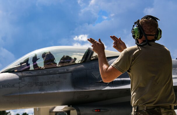 Picture of two Airmen and F-16
