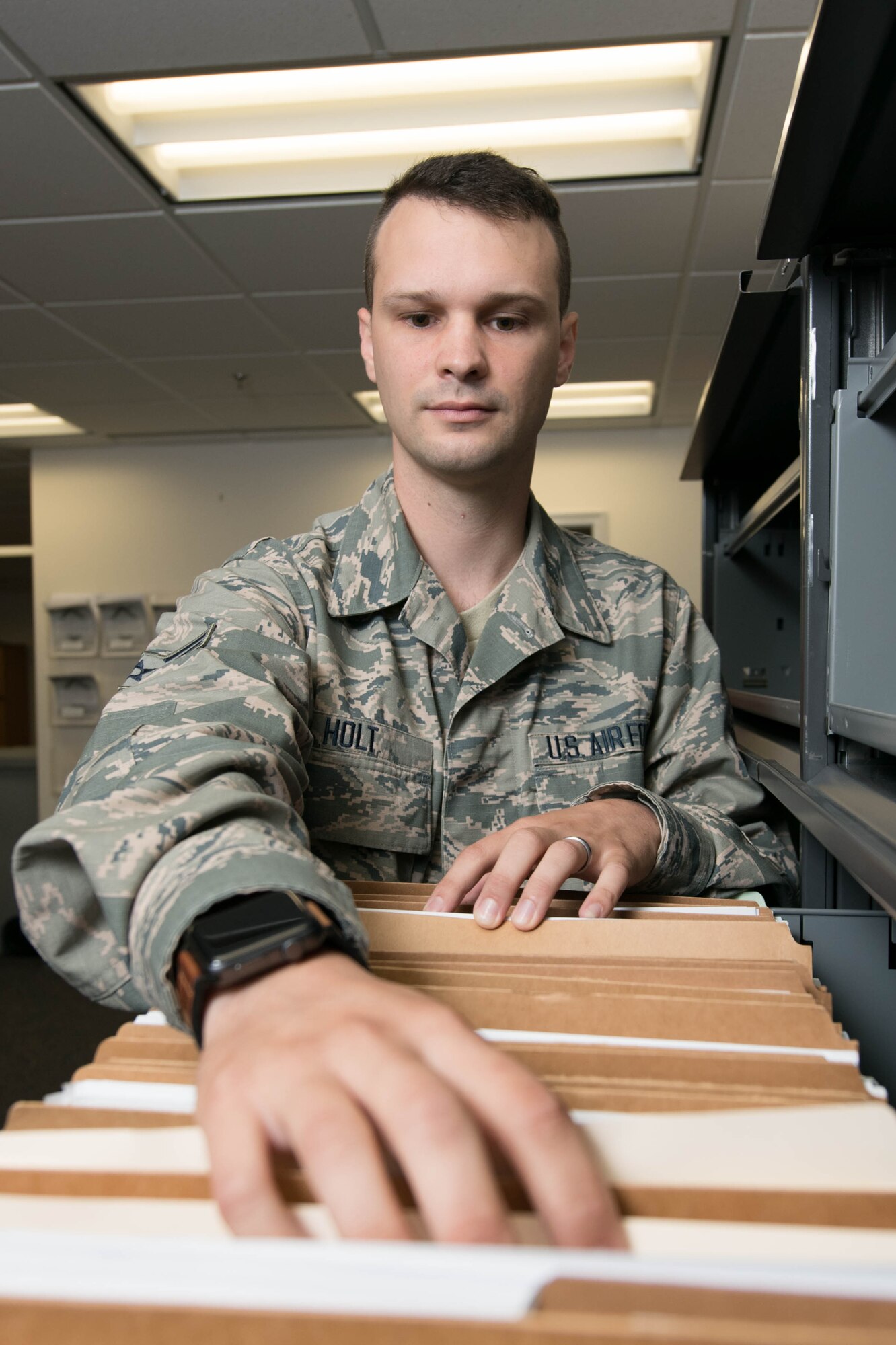 Airman Justin Holt, 436th Comptroller Squadron financial management technician, searches for a customer’s folder in order to add new documents July 28, 2020 at Dover Air Force Base, Del. The squadron keeps hard copies of any adjustments made to pay records for six months. (U.S. Air Force Photo by Mauricio Campino)