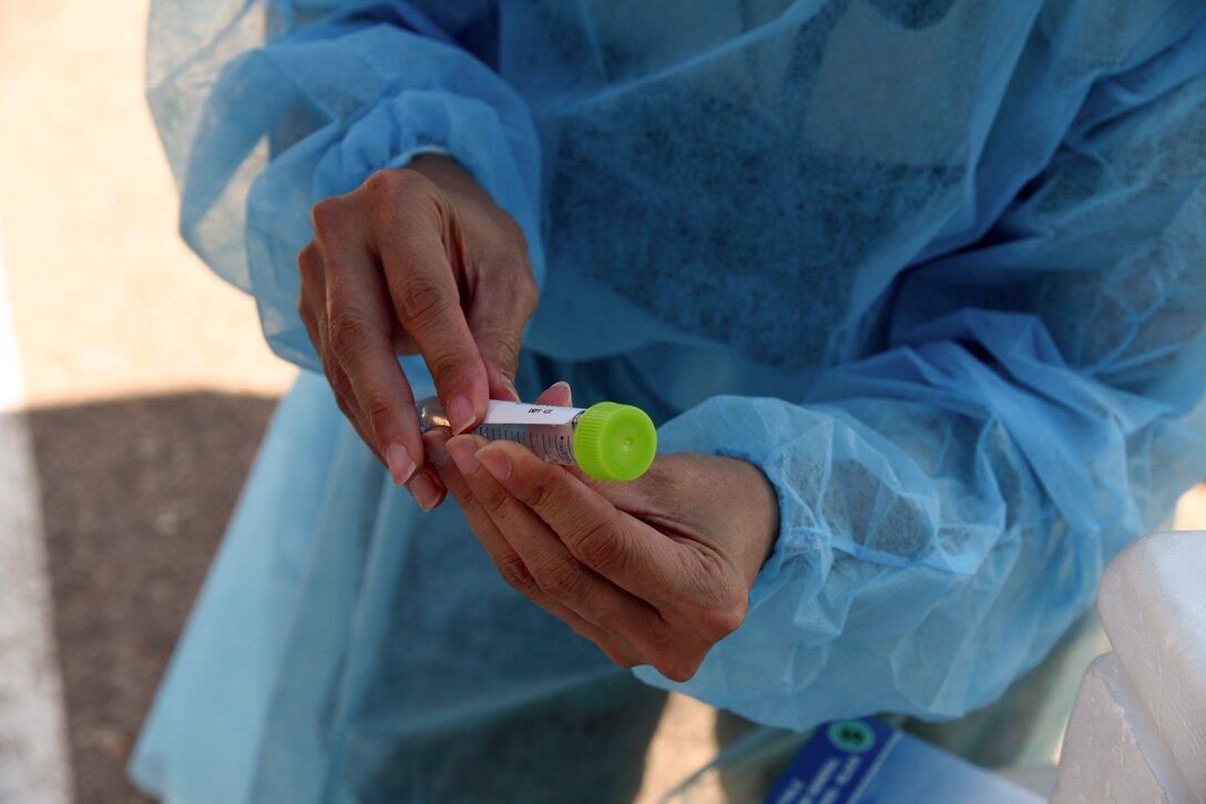 A guardsman holds a test sample.